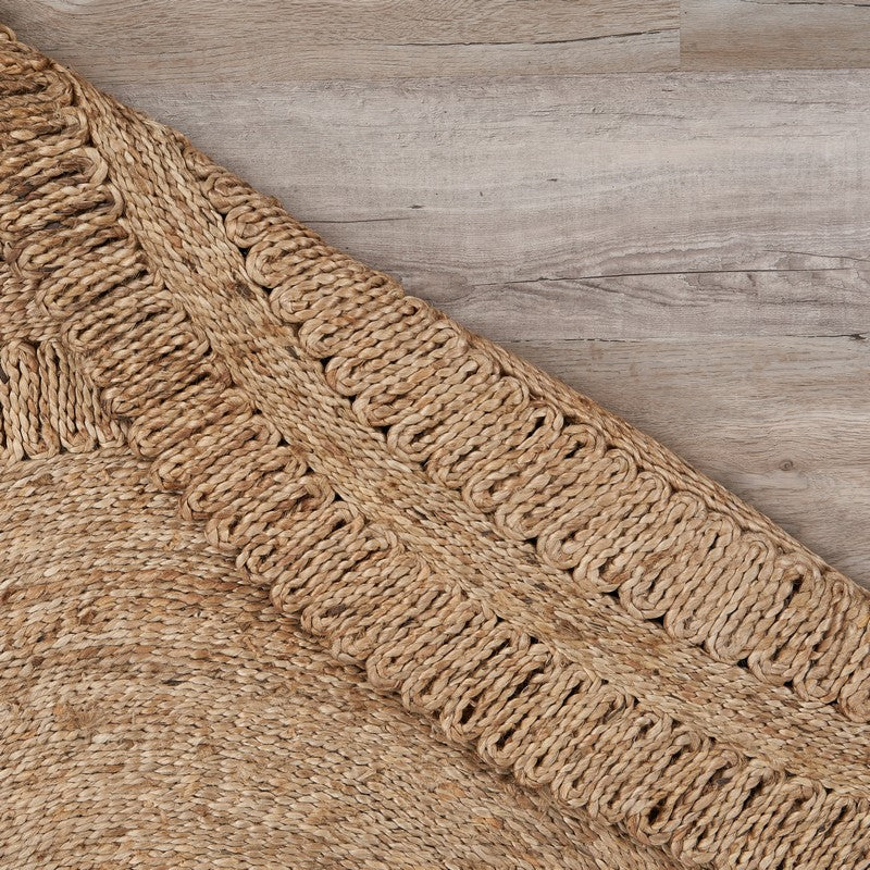 Scallop Grey Natural Fiber Rug laid on wooden floor, adding a touch of natural elegance.