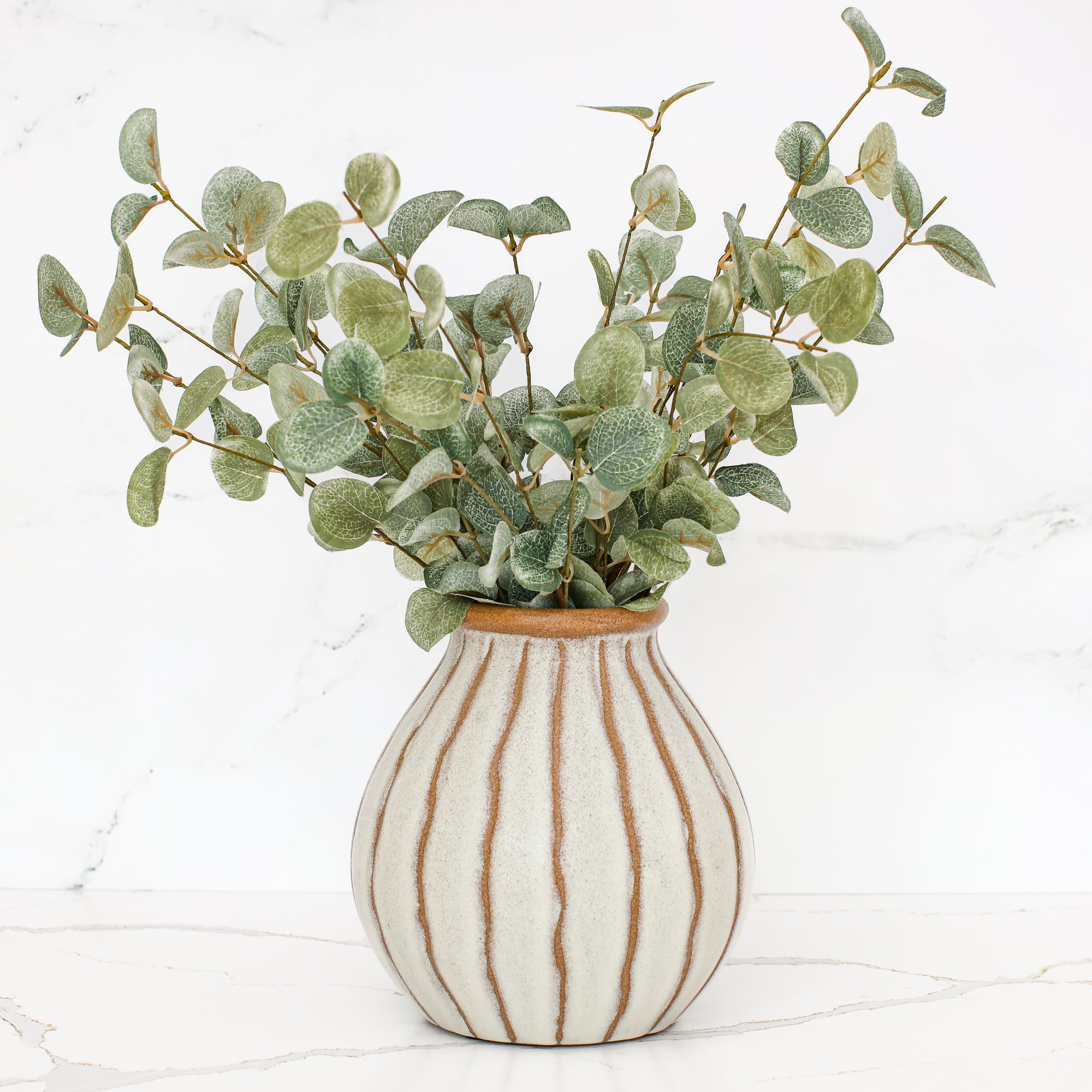 Charming 7" beige stripe ceramic vase, perfect for floral arrangements or as a decorative accent.