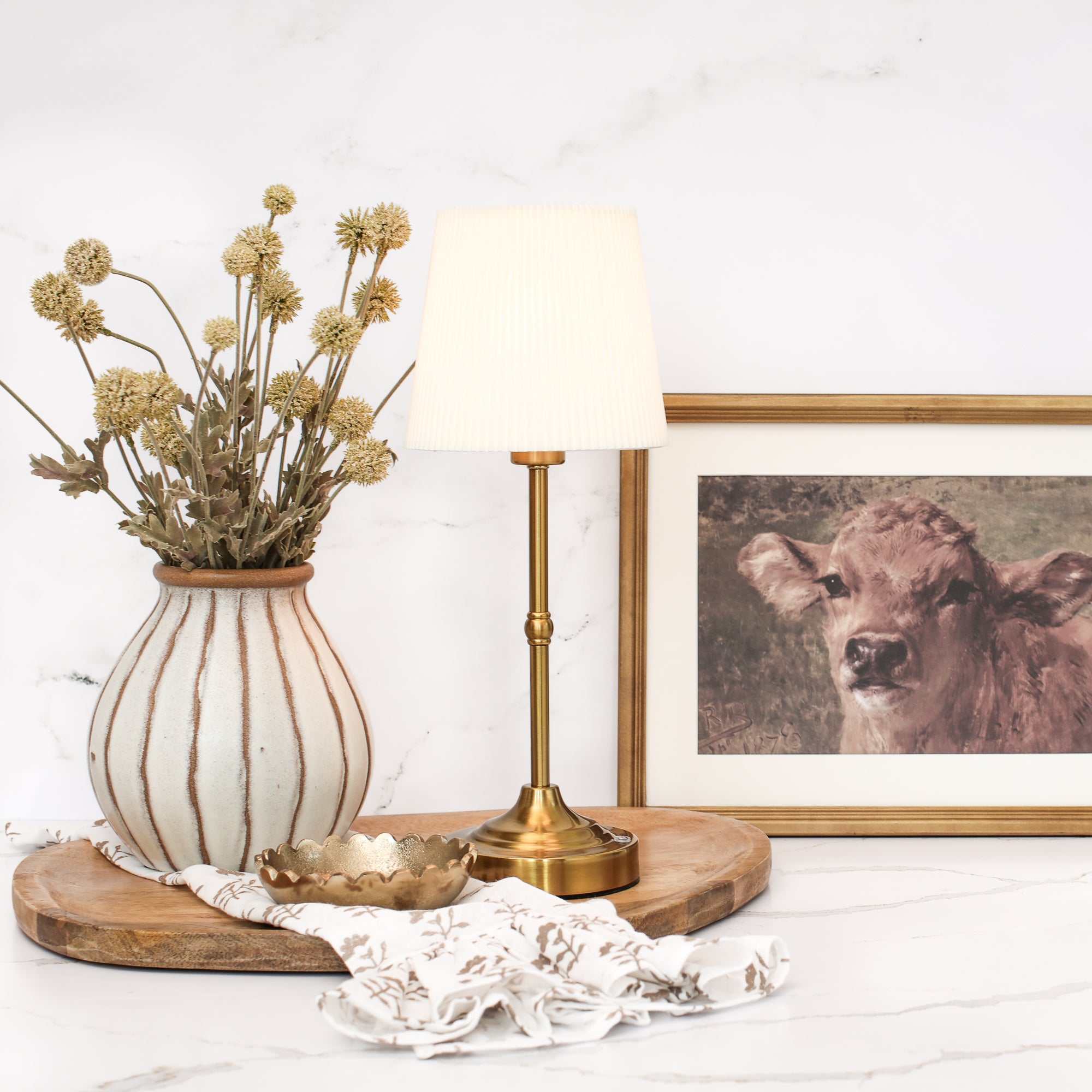 Close-up of the Rechargeable Gold LED Tap Lamp showing its gold base and white pleated shade.