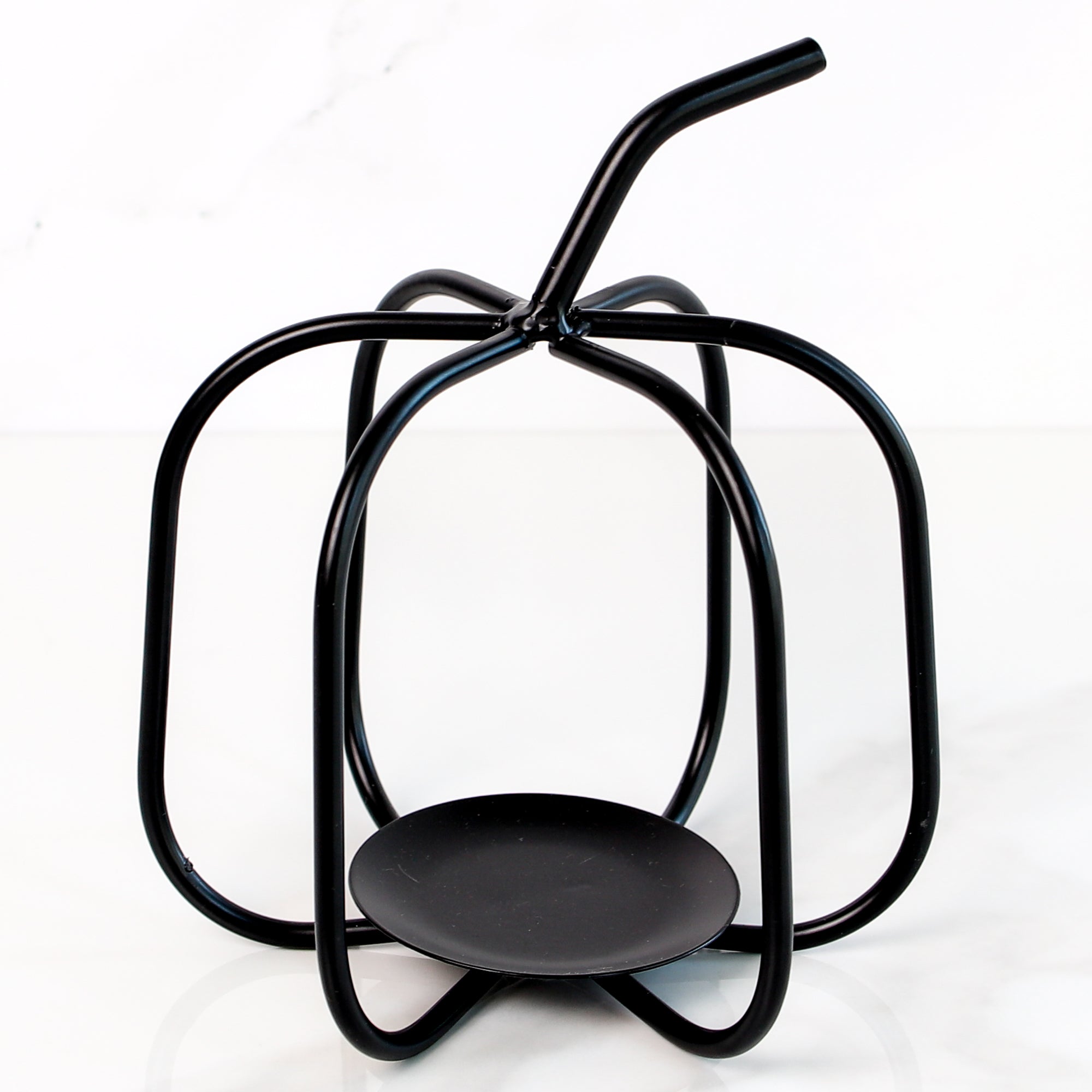 Handcrafted black metal pumpkin candle holder, featuring a rustic design perfect for autumn decor.