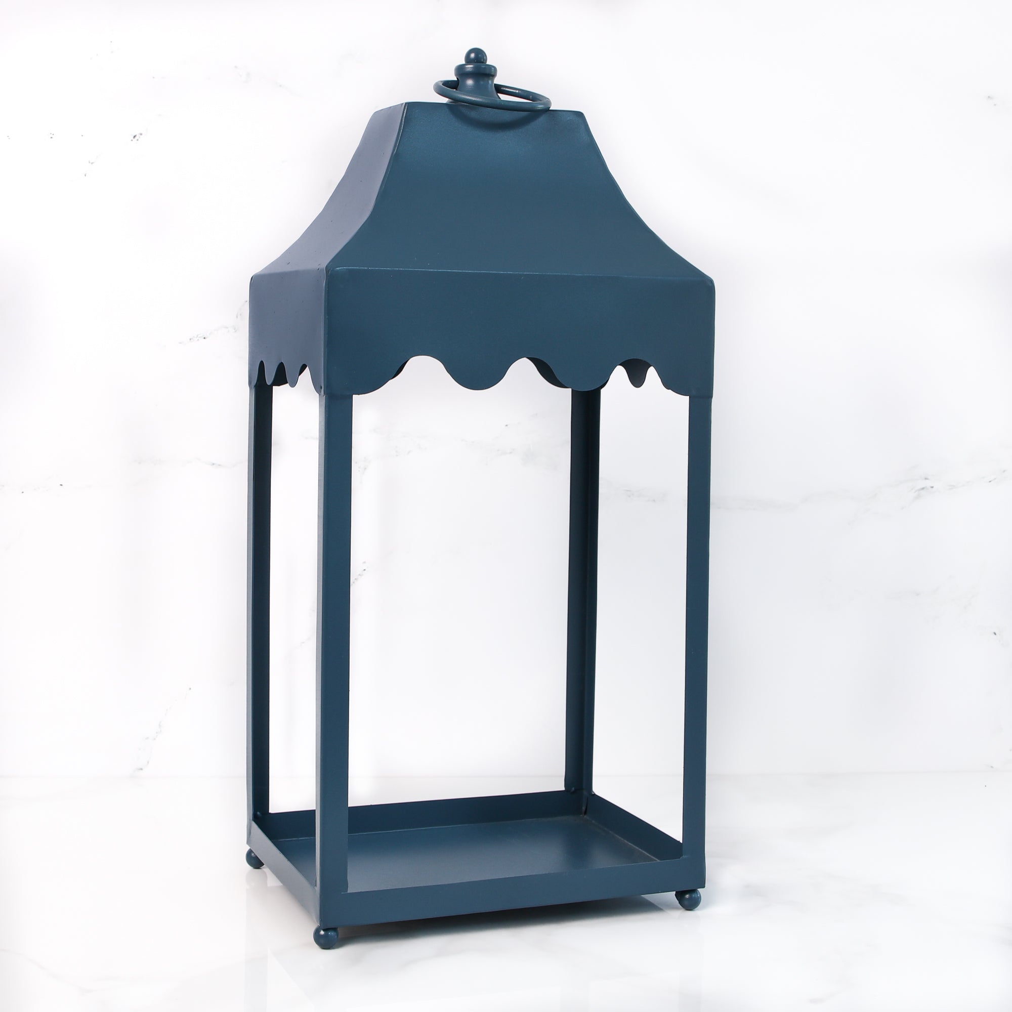 Blue metal lantern with scallop detail, showcasing its charming scalloped design and vibrant blue finish, perfect for adding elegance to your indoor decor.