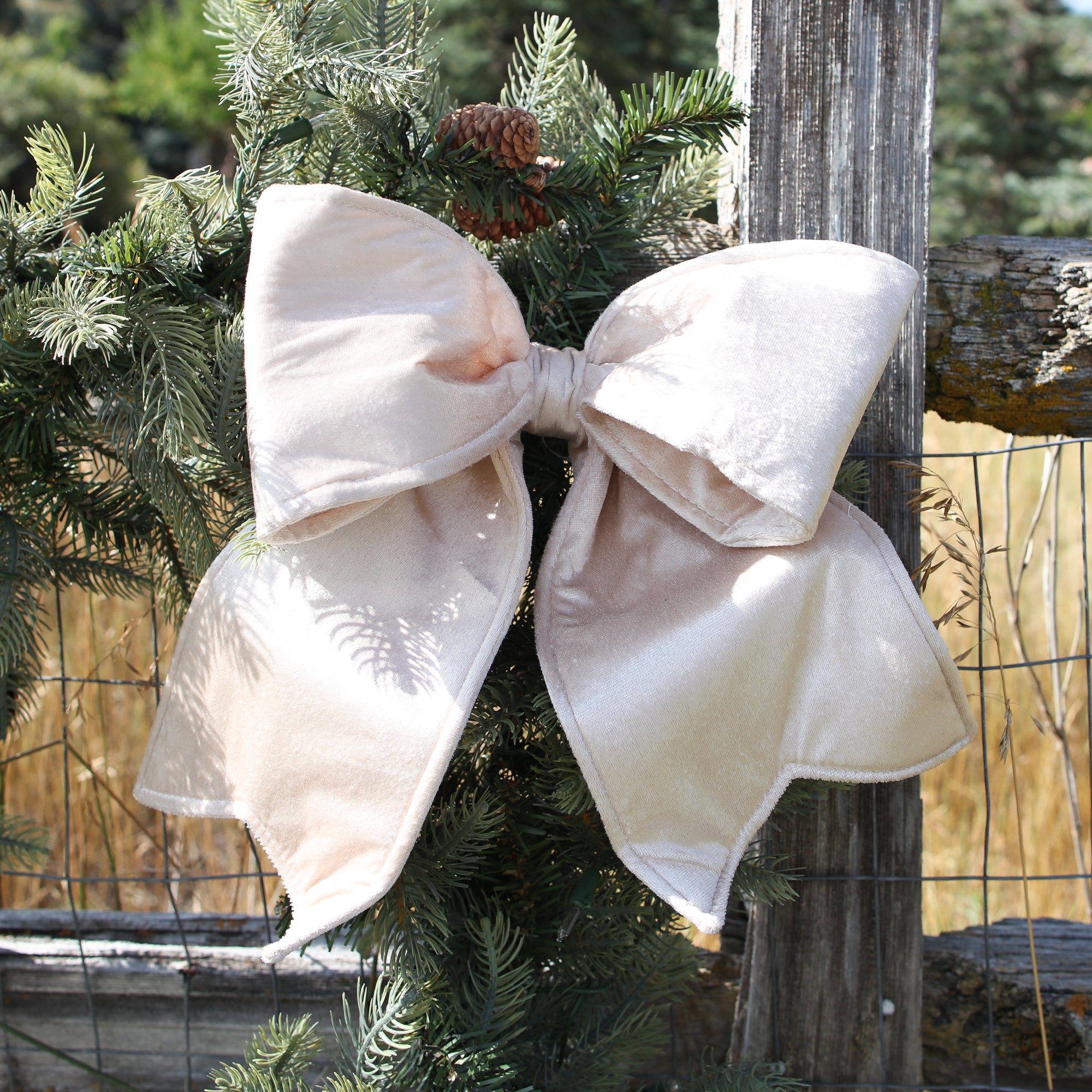 Close-up of Small Champagne Outdoor Velvet Bow showcasing rich champagne color and soft sheen for elegant holiday decor.