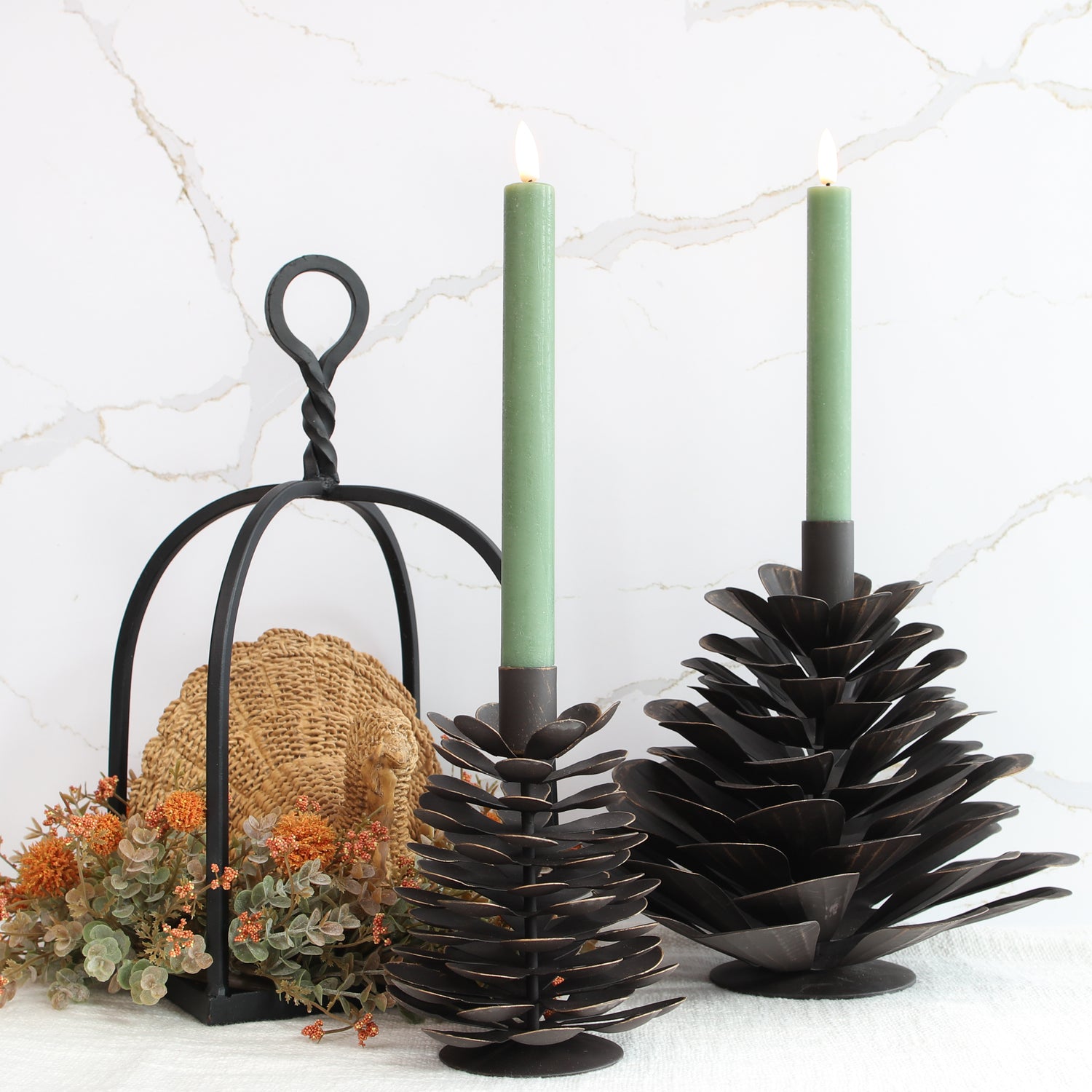 Large Iron Pinecone Candle Holder featuring a rustic design, perfect for cozy autumn settings, crafted from sturdy dark brown iron with bronzed edging.