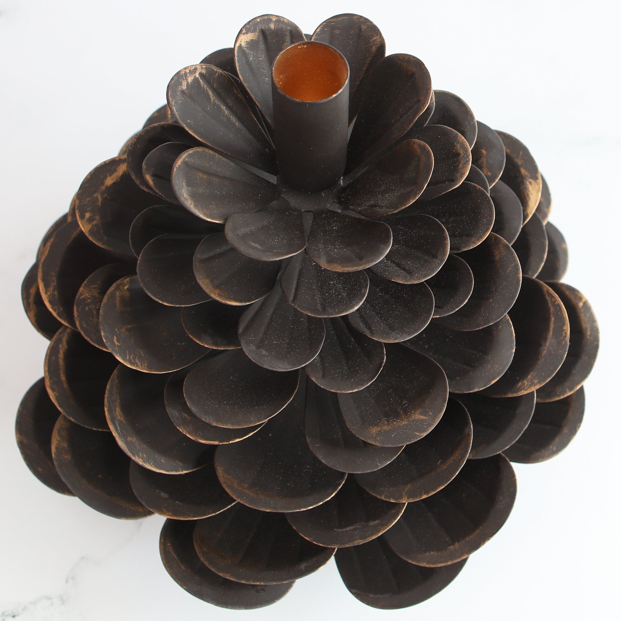 Large Iron Pinecone Candle Holder with a bronzed edge, perfect for festive table settings.