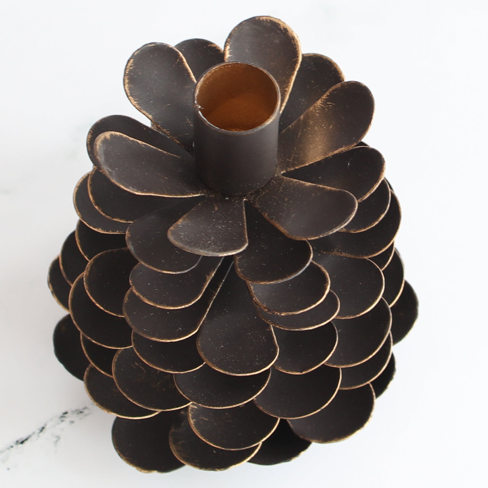 Small Iron Pinecone Candle Holder with dark brown finish and bronzed edges, ideal for cozy settings.