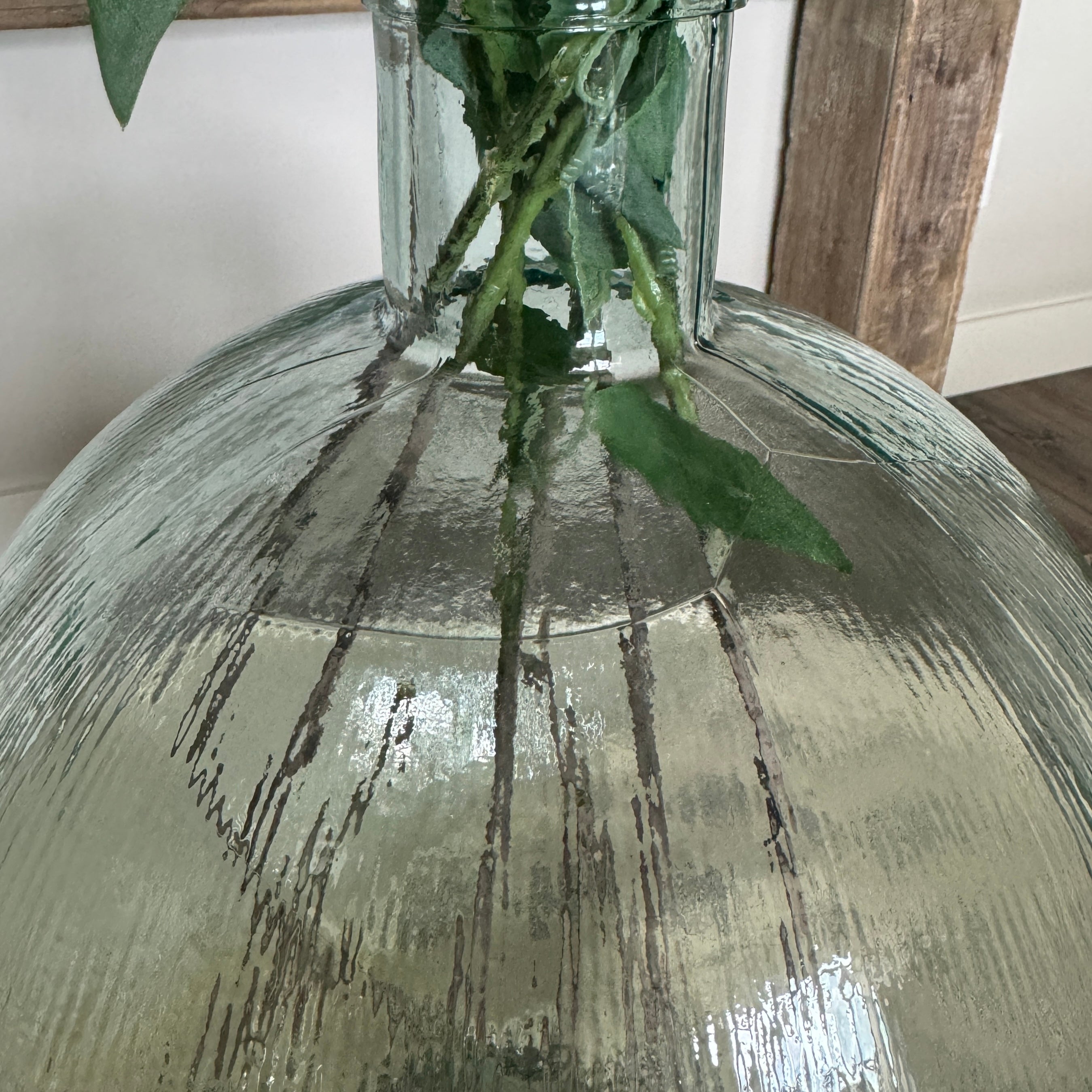 18” Ribbed Vase designed to pair beautifully with dandelions, featuring a clear ribbed texture and dimensions of 13.5" x 13.5" x 18".