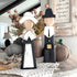 Decorative wooden pilgrims boy and girl figures, perfect for Thanksgiving decorations and seasonal home decor.