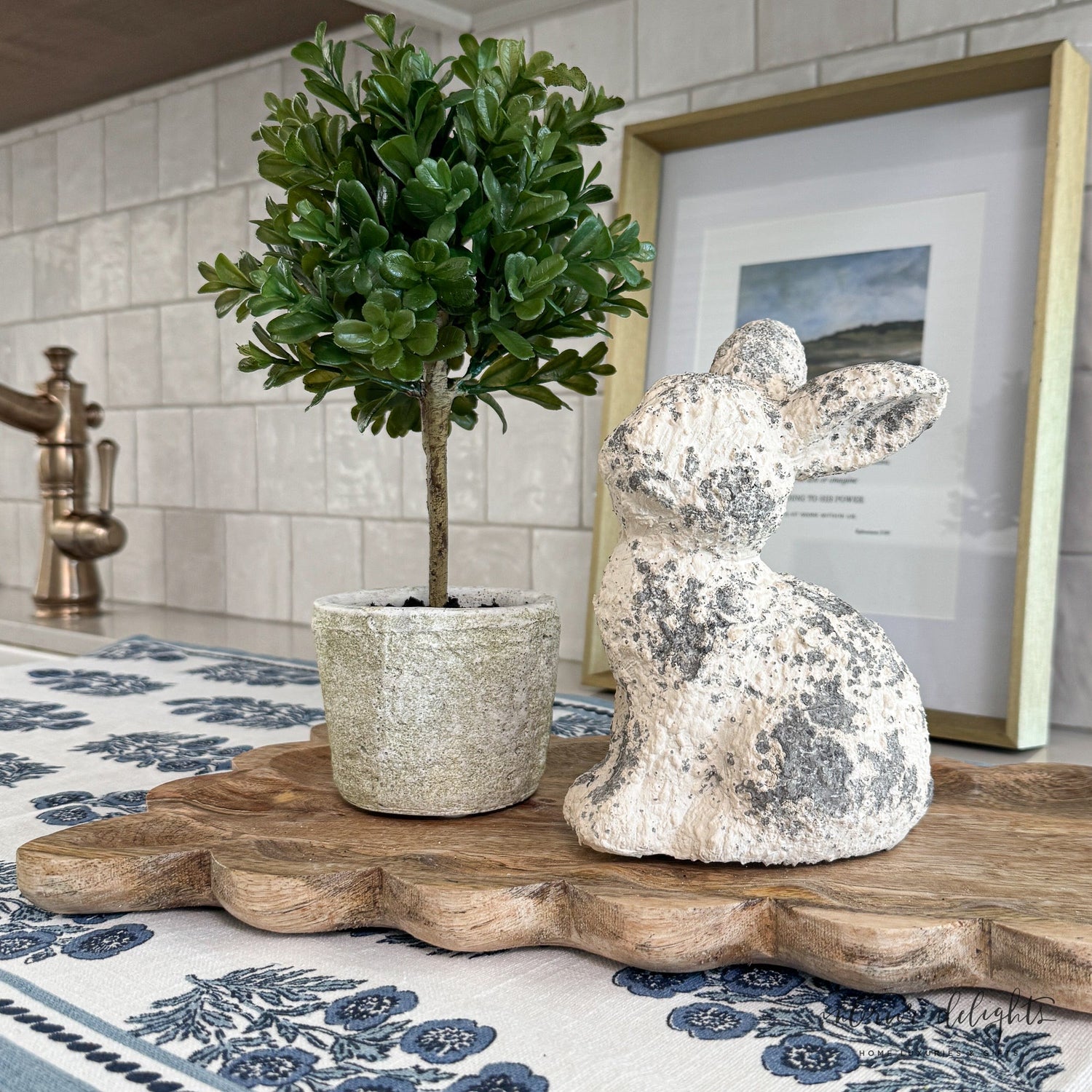 11” Green Boxwood Topiary in Clay Pot styled on a tabletop, adding elegance to any space.