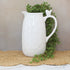 10” White Ceramic Pitcher with Bird, featuring a charming bird detail and hammered texture, perfect for serving drinks or displaying flowers.