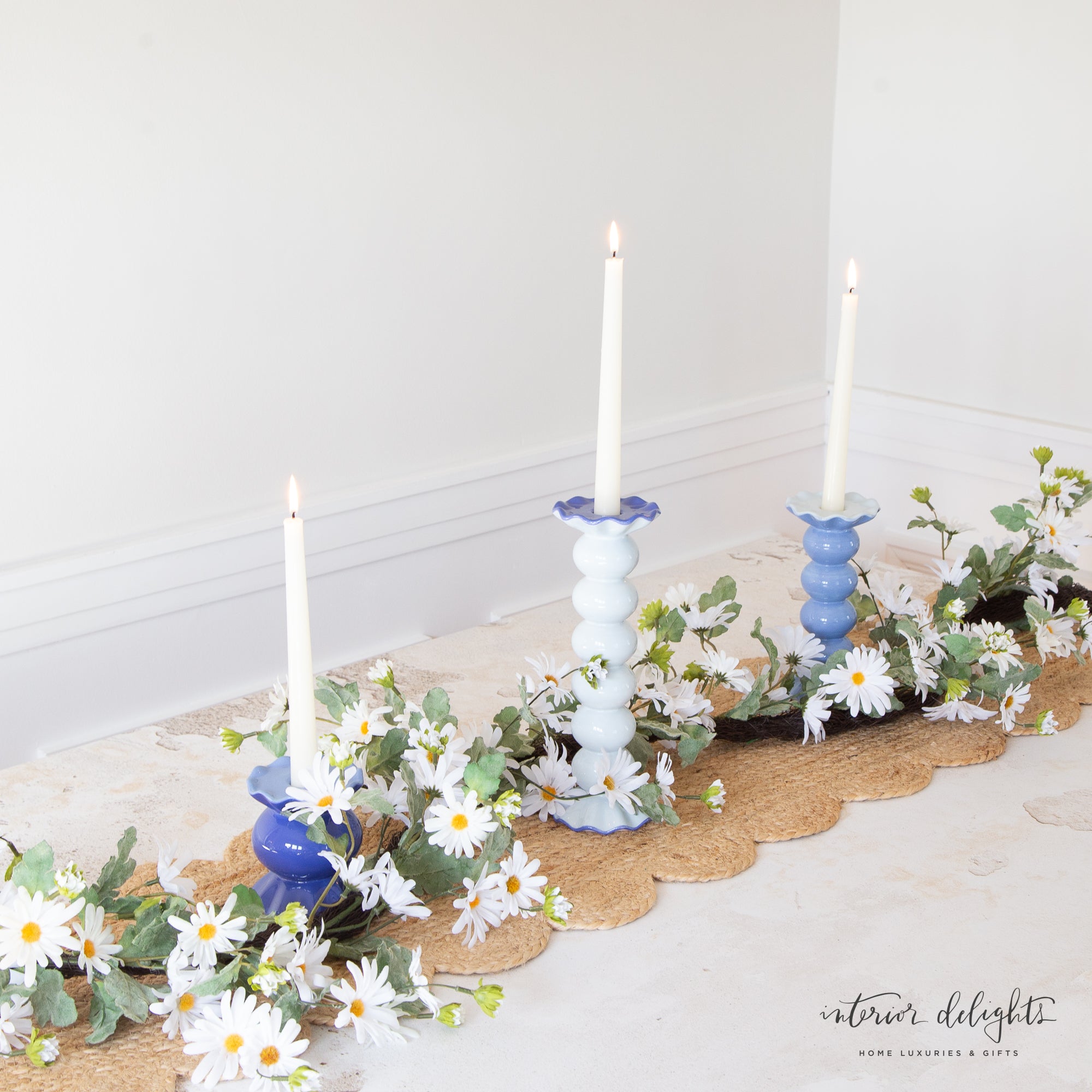 White Shasta Showers Garland featuring delicate white daisy flowers on a natural-looking green vine, perfect for decorating spaces like mantels and doorways.
