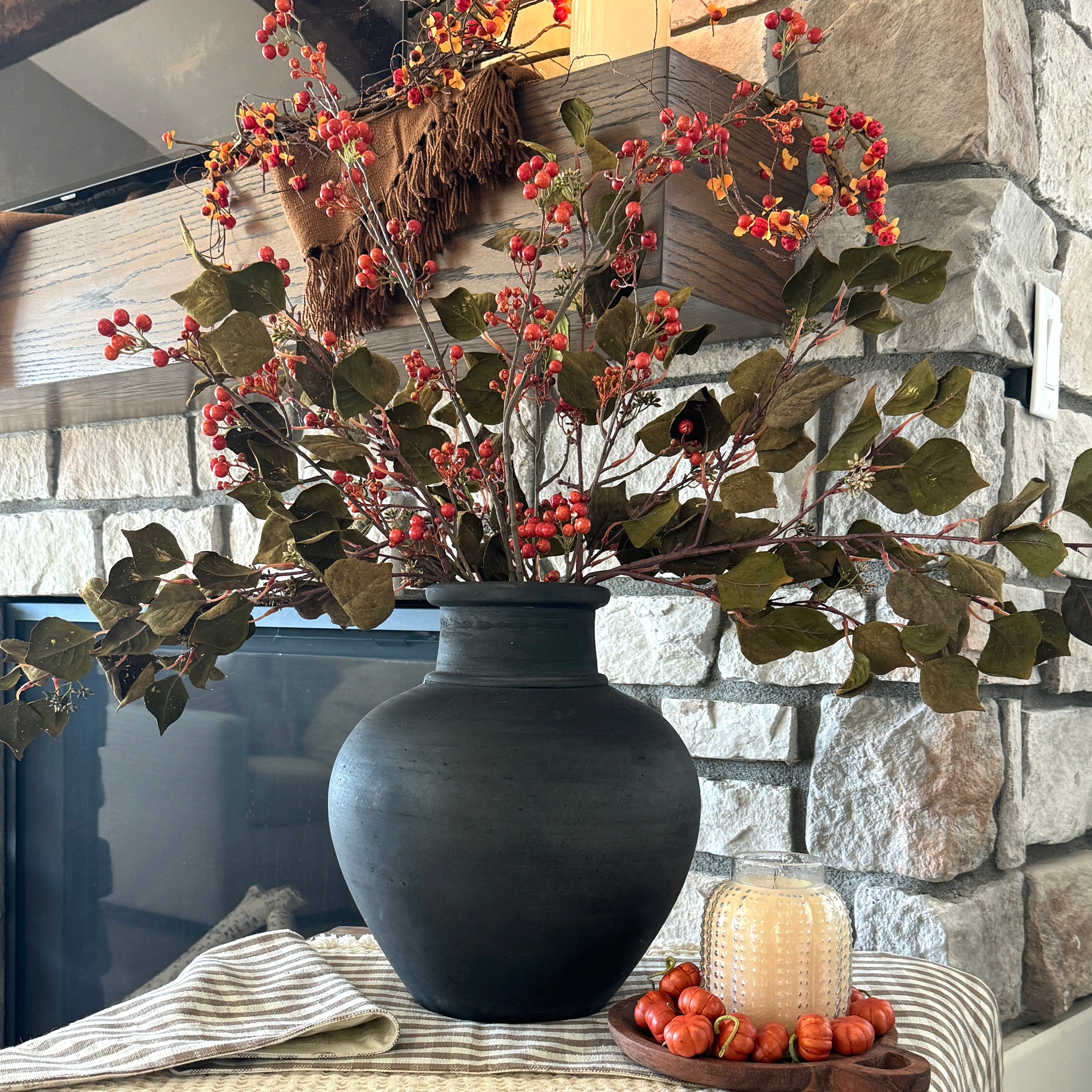 Stylish 13.5 in Black Terracotta Vase filled with autumnal decor, including Berry Sprays and Eucalyptus Stems.