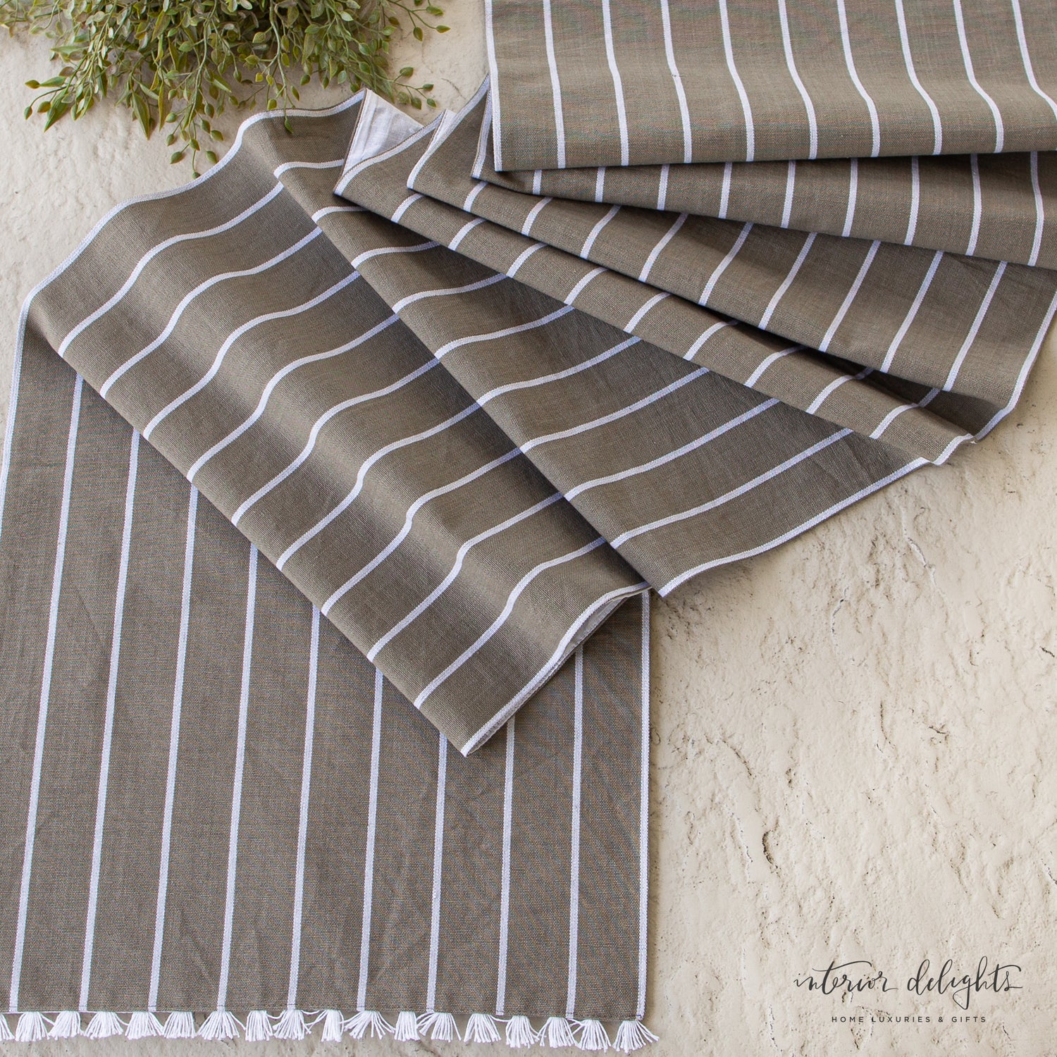 Close-up view of the Striped Table Runner with Fringe, highlighting the subtle pattern and texture in natural light.