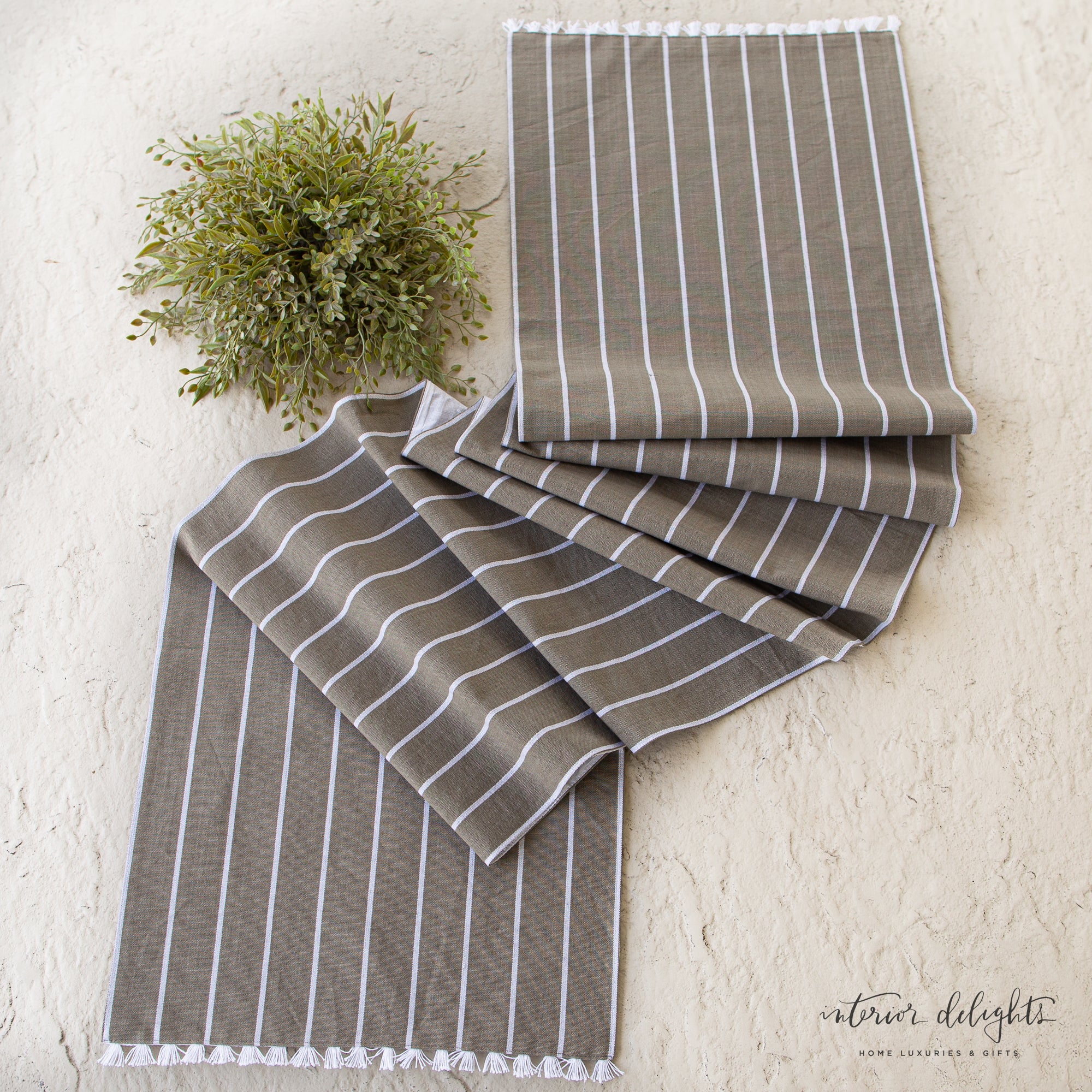 Striped Table Runner with Fringe on a dining table, showcasing its soft woven fabric and delicate white thread fringe detail.