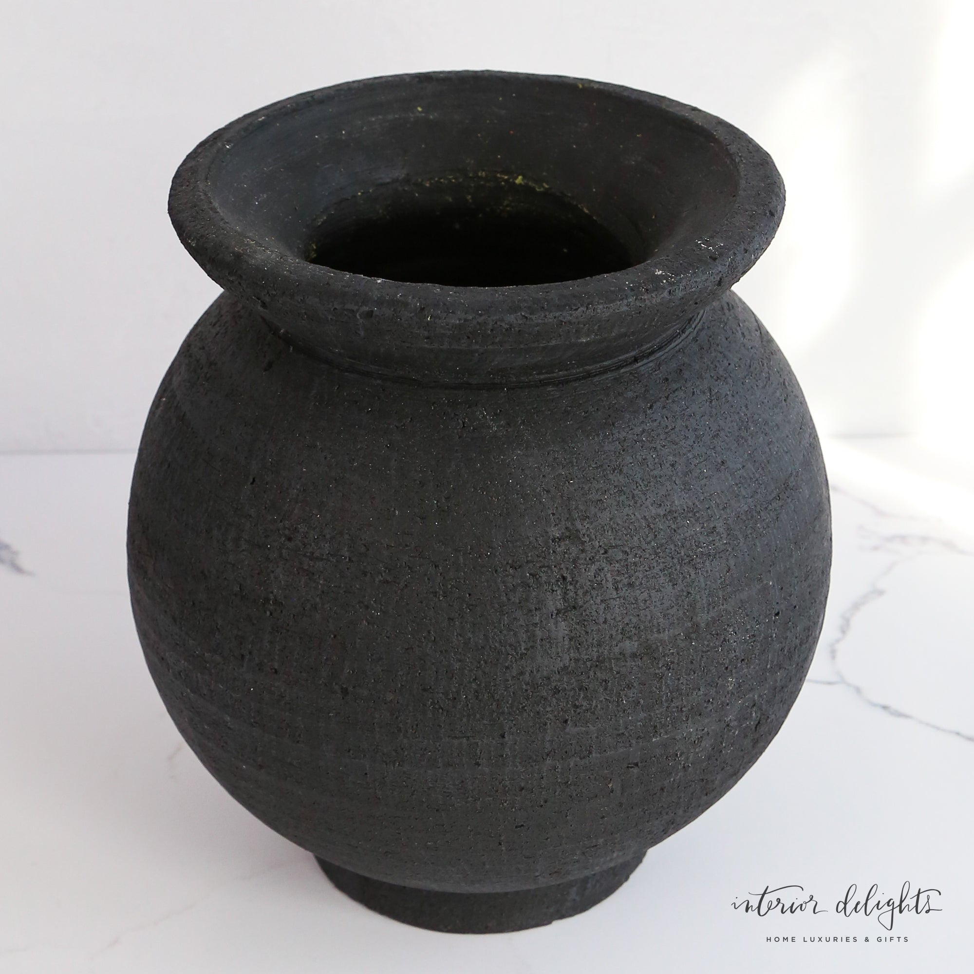 Elegant 9.5" Black Paul Vase with beautiful craftsmanship, perfect for pairing with plants or decorative garlands.