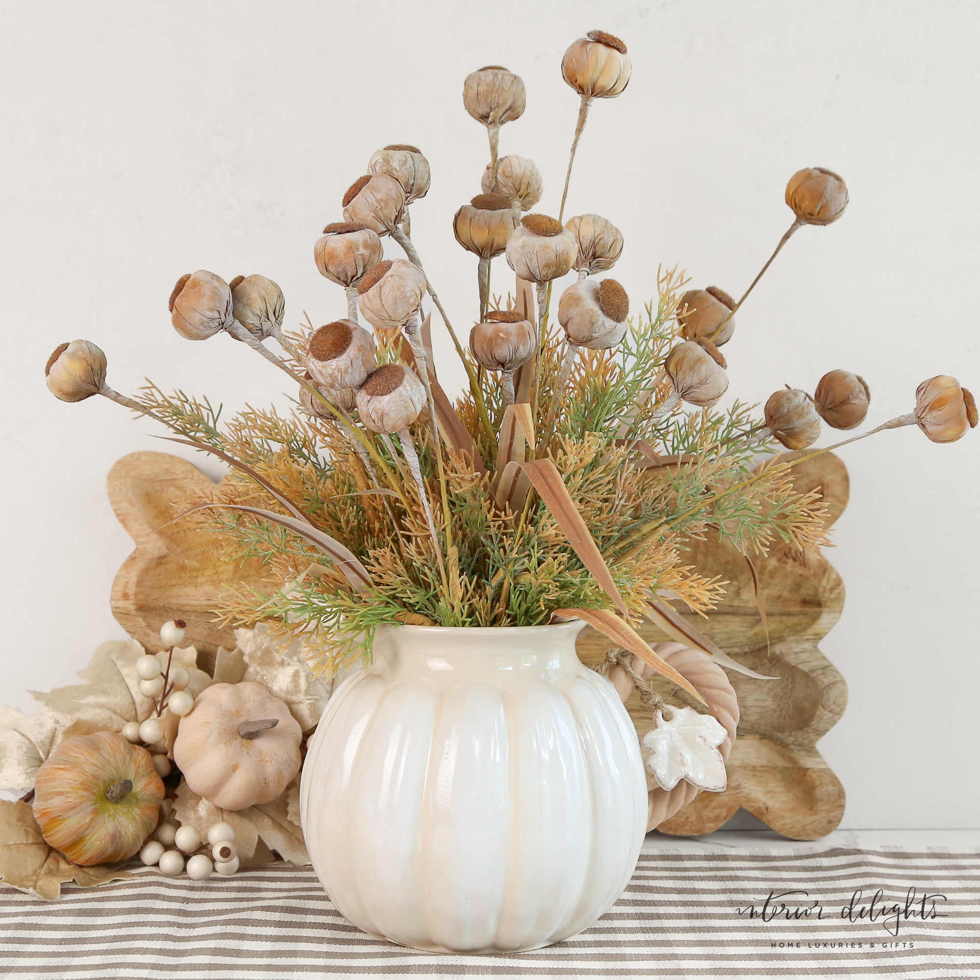 Stylish white pumpkin pitcher featuring a cute vine handle, great for adding seasonal flair to your kitchen.