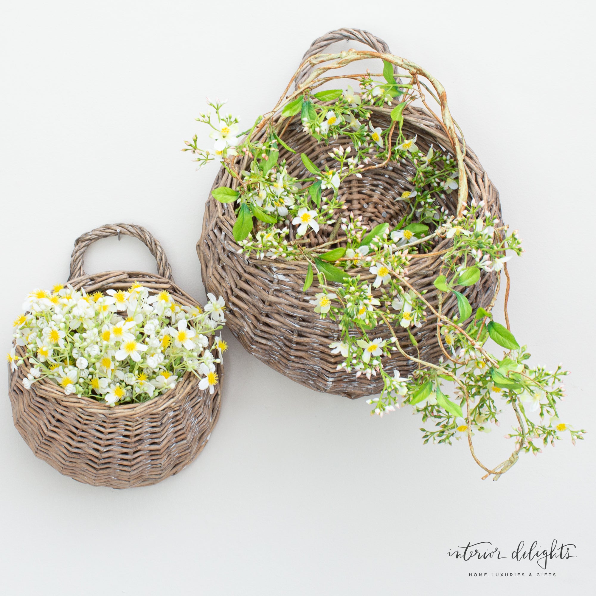 5ft Mini Flower Garland styled in a cozy setting with round willow baskets and the White Mini Daisy Bundle.
