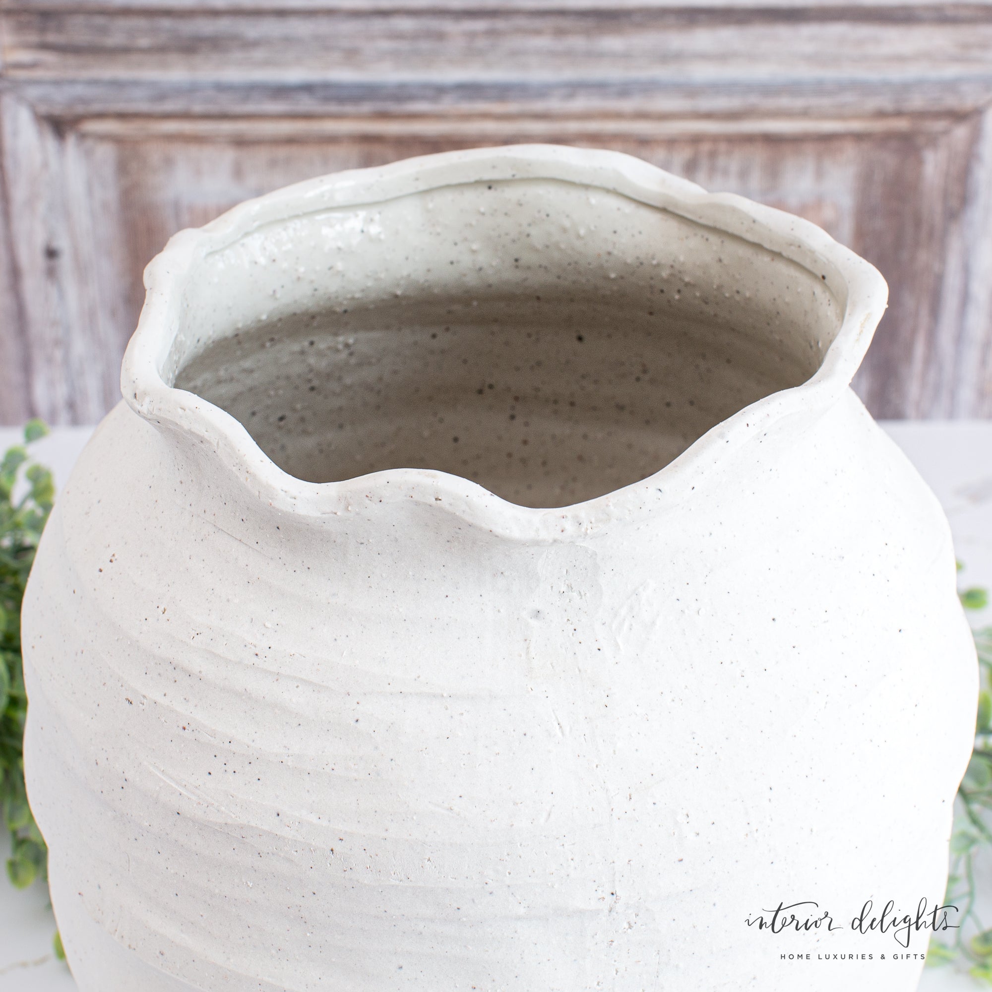 Side angle of the 12” Ivory Scalloped Top Stoneware Vase highlighting its delicate scalloped top design