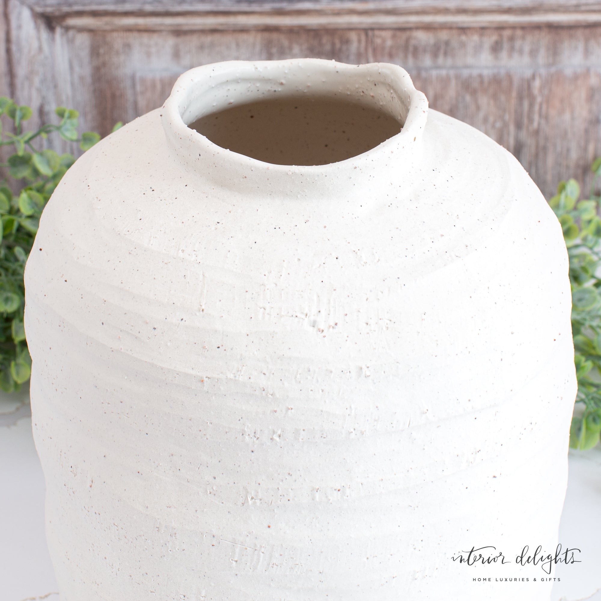 10.5” Ivory Stoneware Vase styled with fresh flowers, demonstrating its charm and versatility in home decoration.