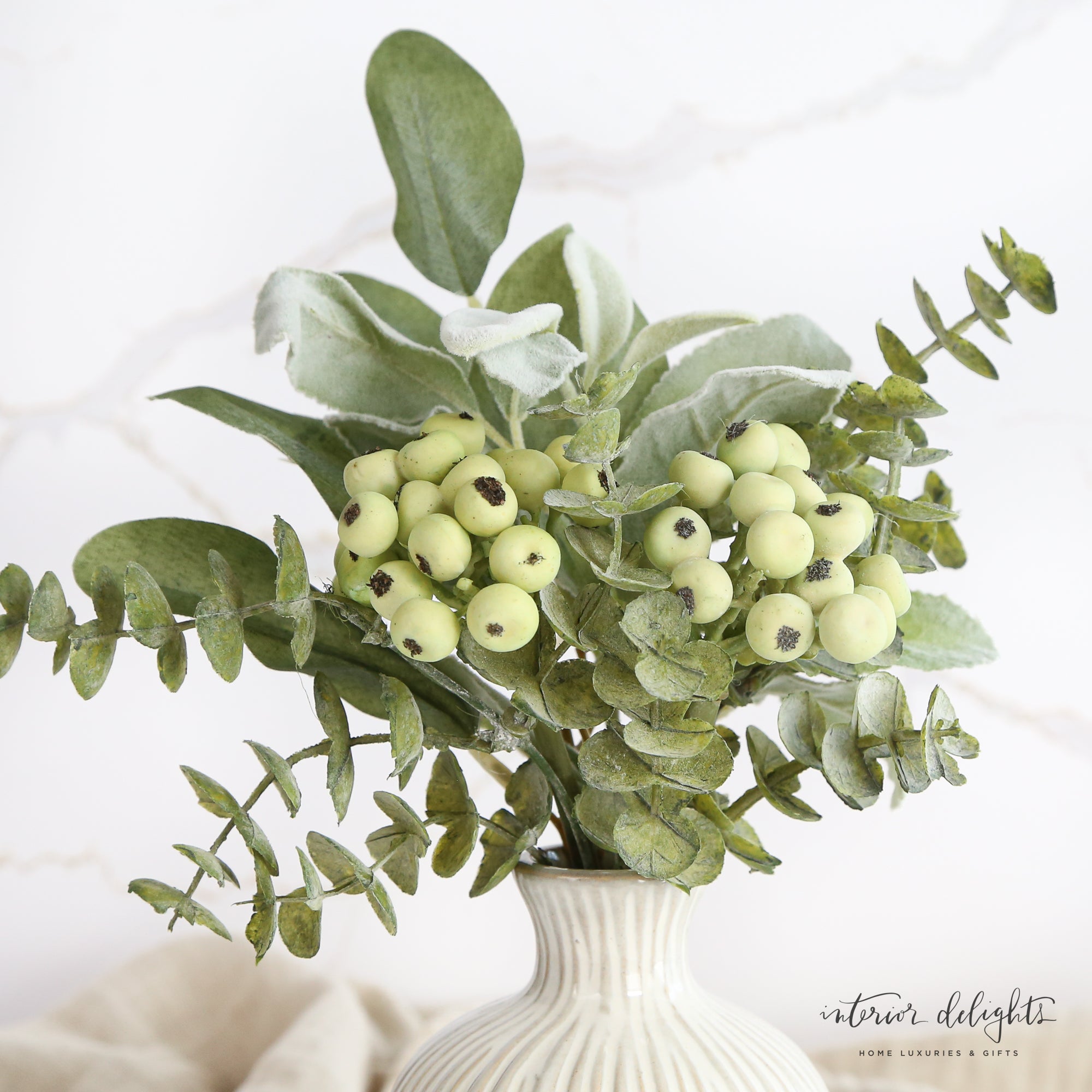 Mixed Green Foliage with Berries Bundle displayed in a decorative vase, showcasing realistic green leaves and vibrant berries for year-round home decor.