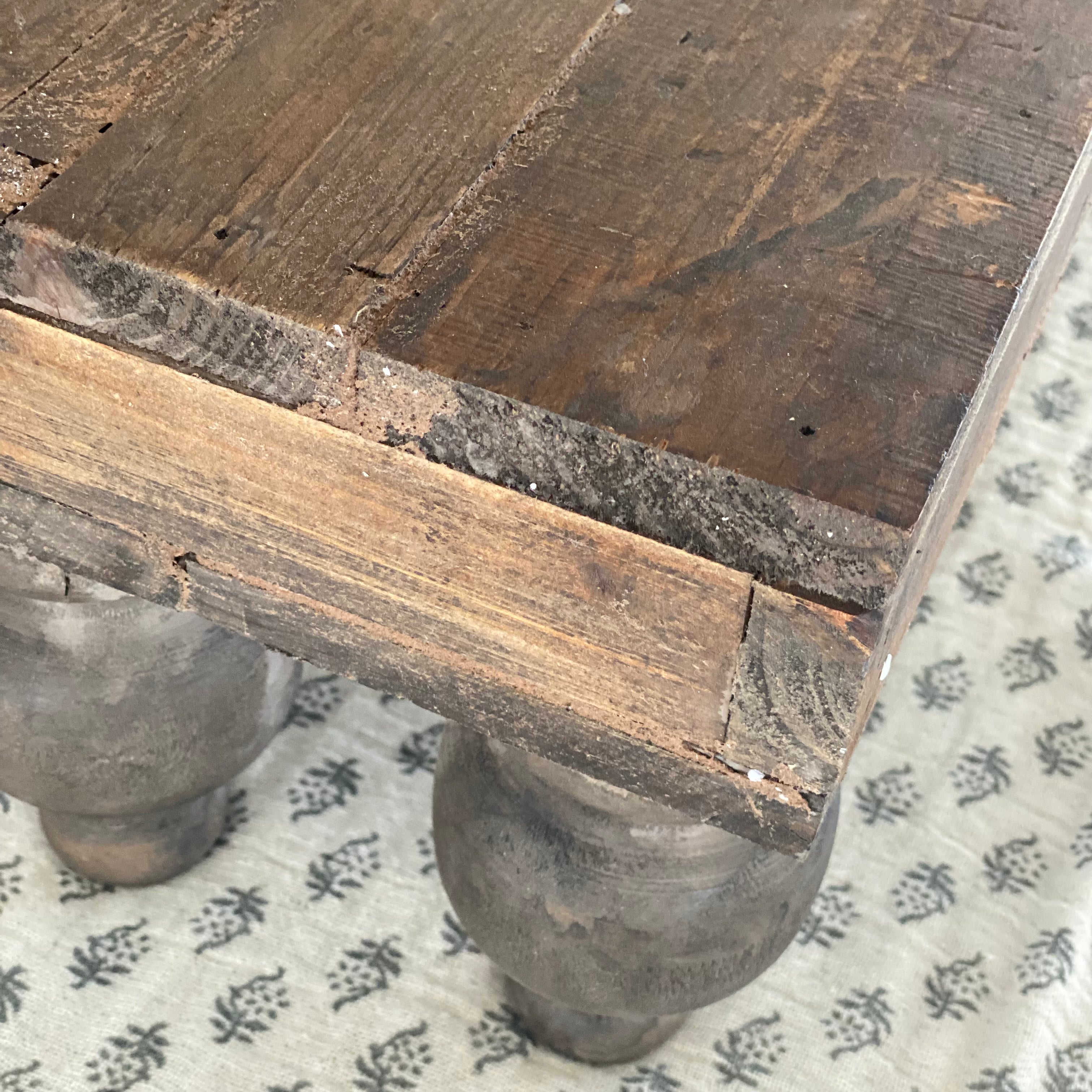 Rustic Footed Wood Riser placed elegantly on a dining table, showcasing its unique rustic design and weathered finish.
