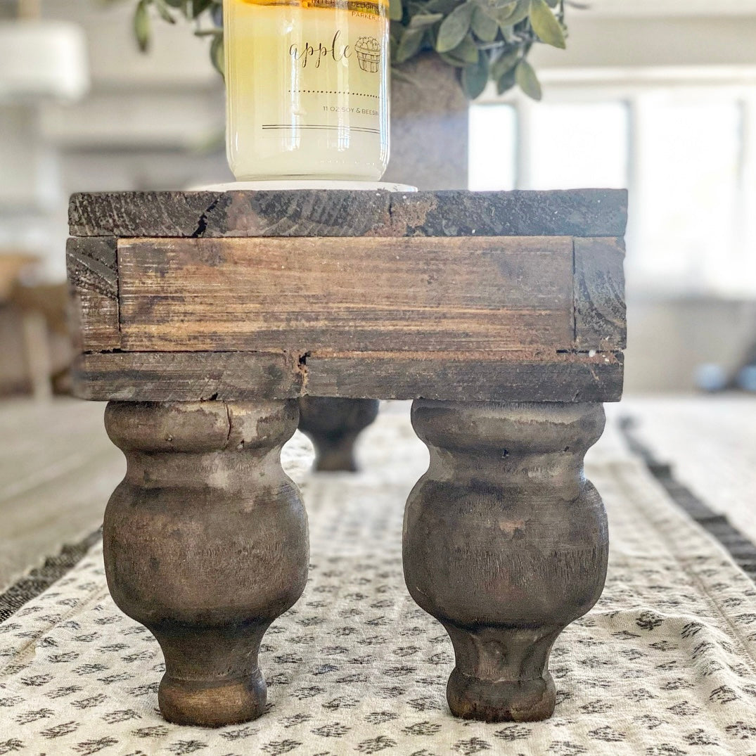 Overview of Rustic Footed Wood Riser with rustic wood tones, highlighting its unique character.