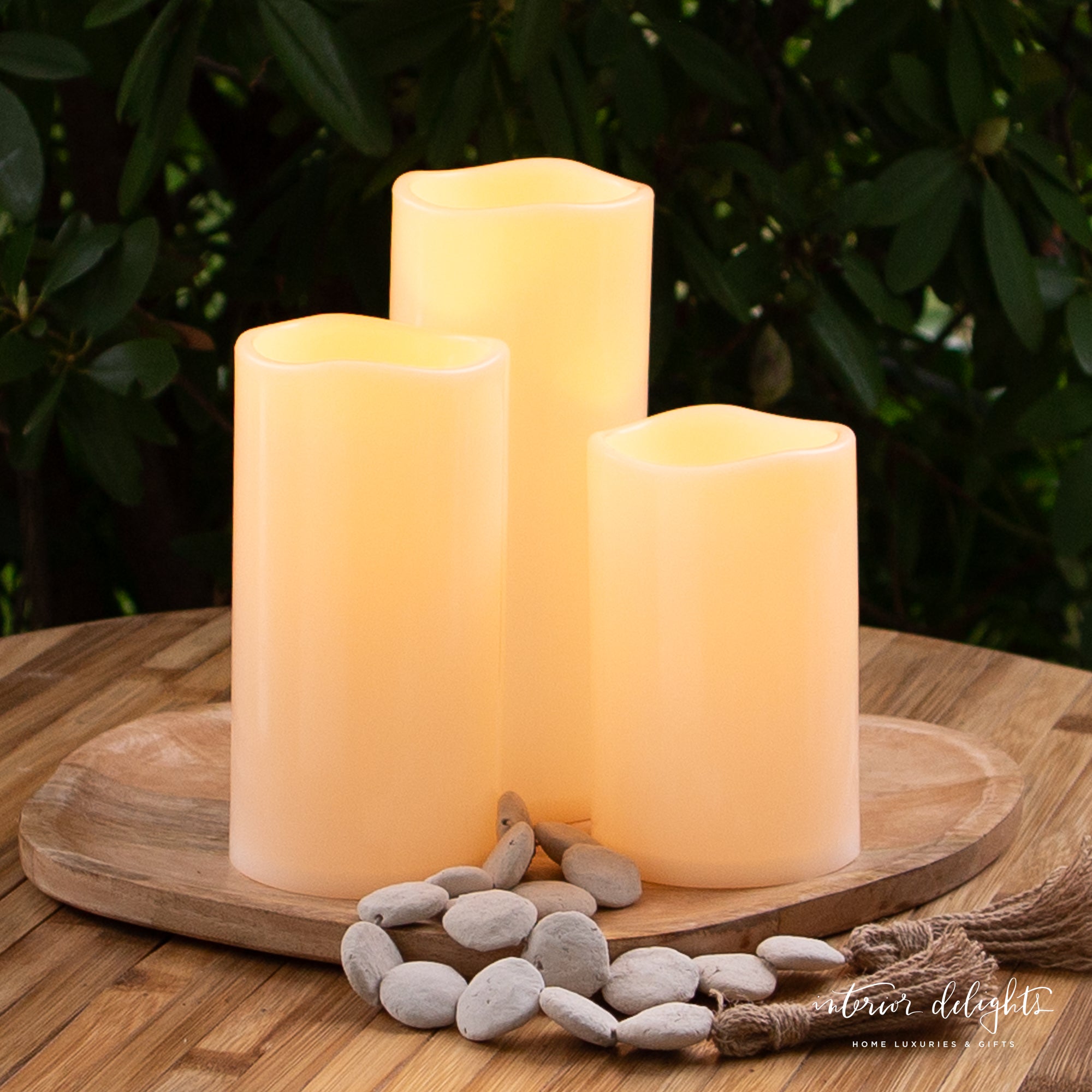 Set of 3 outdoor LED candles, weather-resistant, emitting a warm white flickering glow, perfect for creating a cozy atmosphere outdoors.