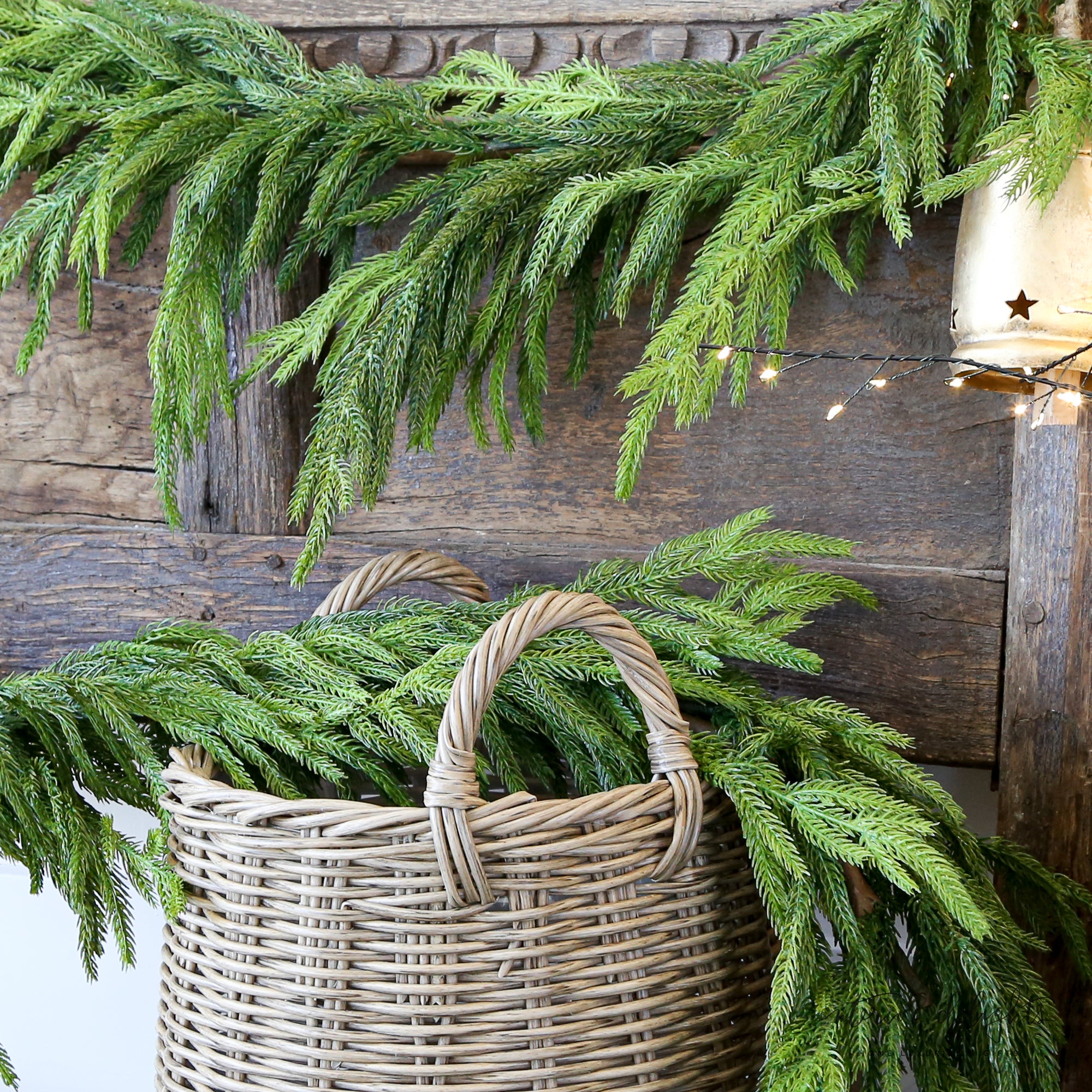 Close-up view of the 15ft Real Touch Norfolk Pine Garland highlighting the dense faux branches and lifelike texture, perfect for stylish holiday decorating.