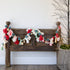 Garland with Pom Poms and Metal Bells, adding a colorful and festive touch to holiday decor, perfect for mantels and doorways.