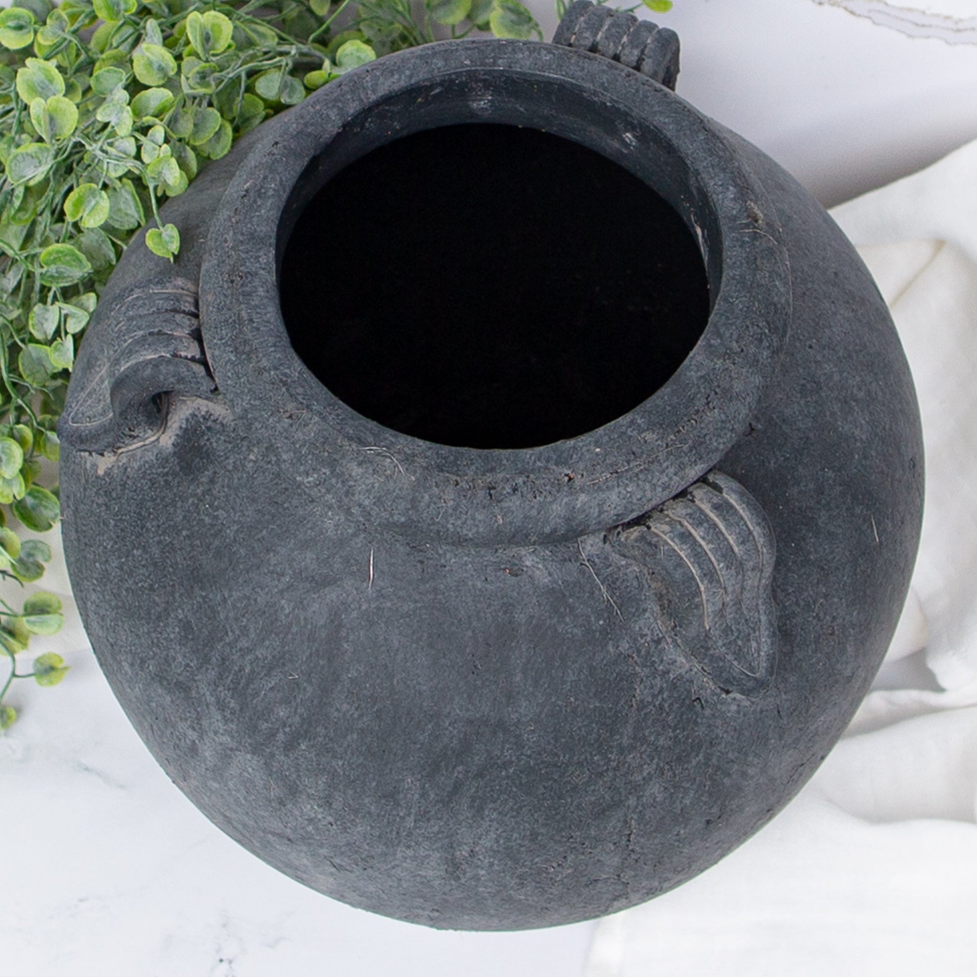 11" Charcoal Clay Pot displayed with decorative greenery, showcasing its versatility as a standalone decor piece.