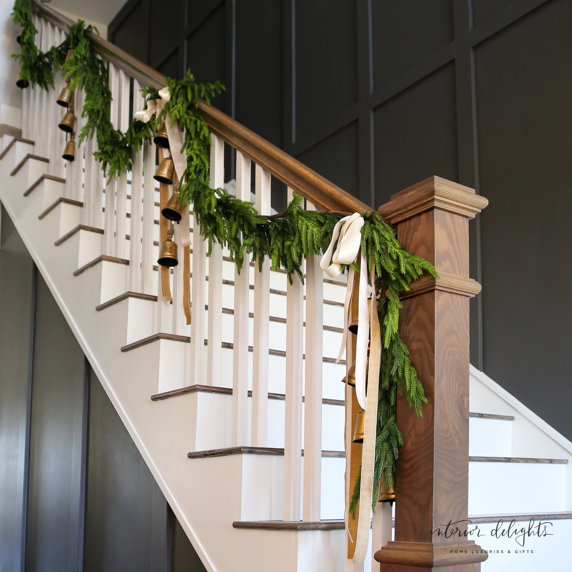 Lifestyle image of Vintage Flared Bells on Jute Hanging Rope hung on a front door, adding festive charm to Christmas decorations.