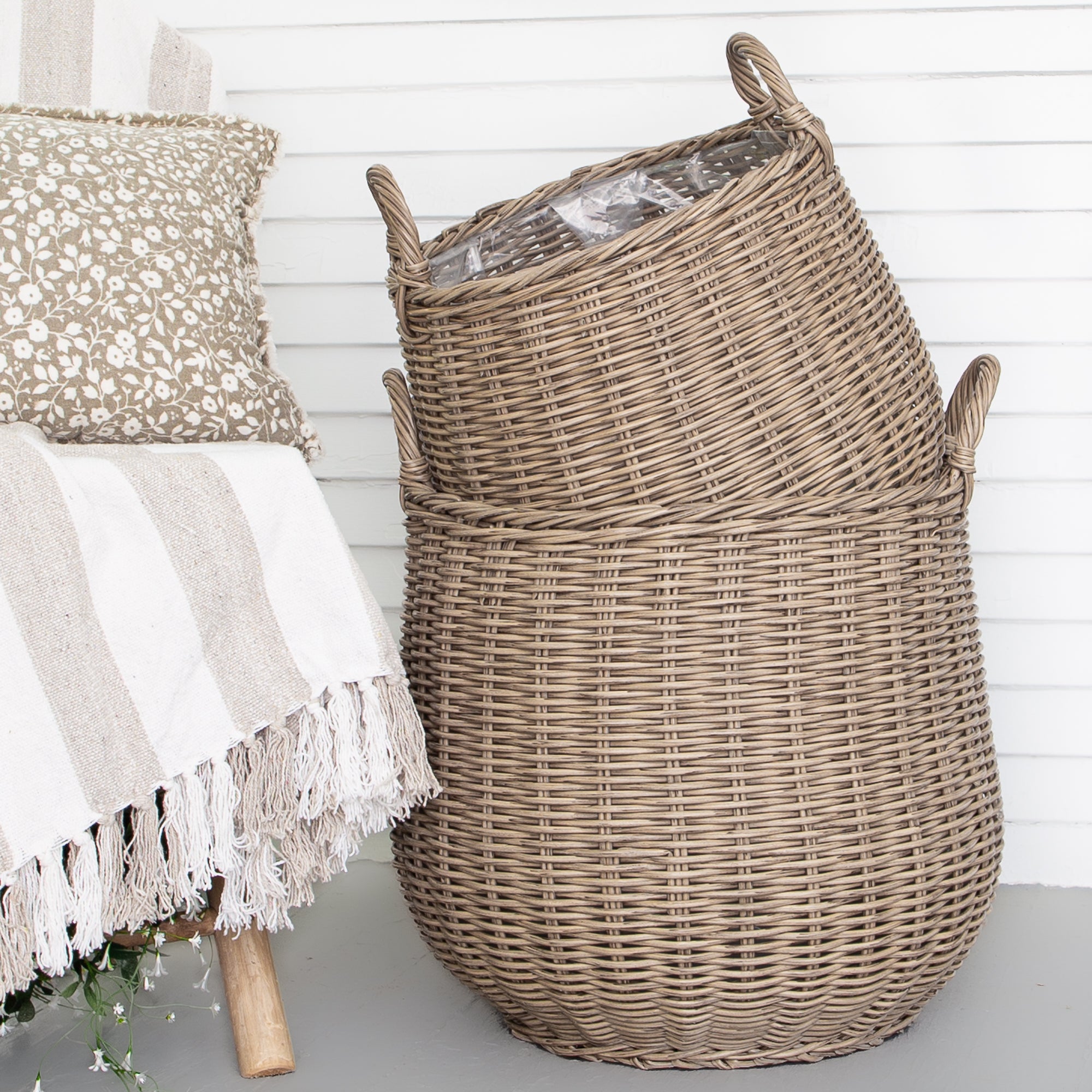 Round Willow Planter Baskets - Set of 2 showcasing rustic design with sturdy side handles and plastic lining for outdoor charm.