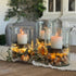 Medallion Hurricane Candle Holder in clear textured glass with dark metal insert, perfect for all-season decor.