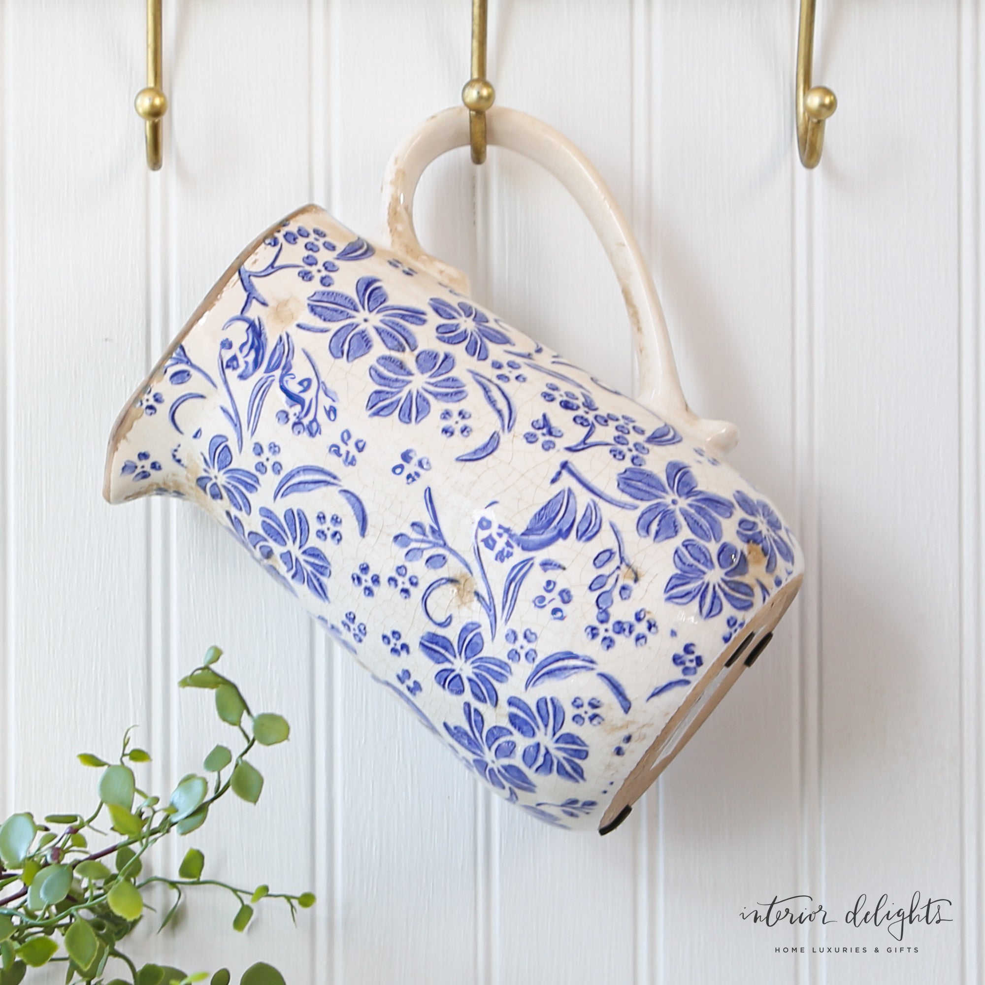 Close-up of Ceramic Blue Floral Pitcher showcasing the cream glaze and floral details.
