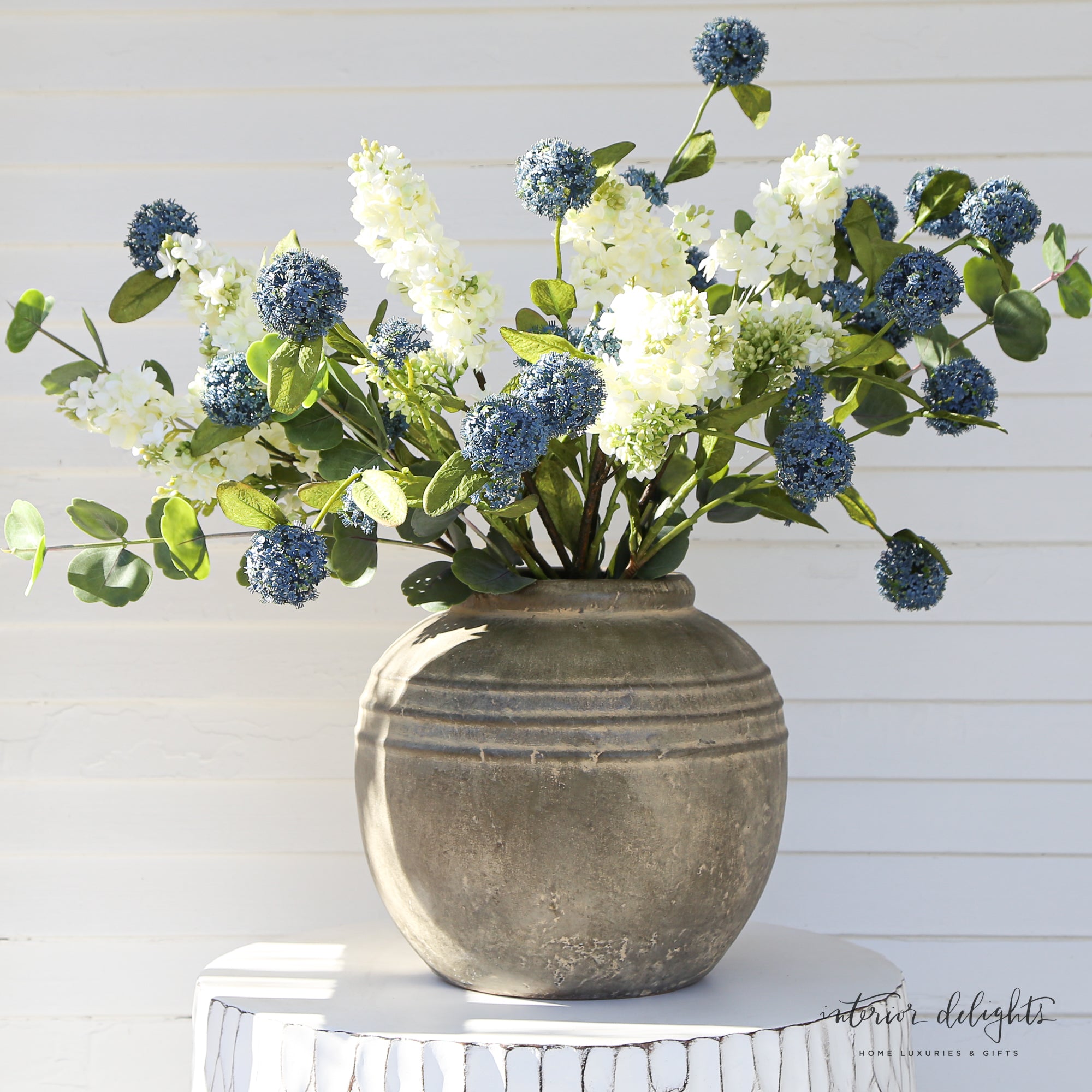Versatile Blue Snowball Spray adding a pop of color in a stylish vase, perfect for bouquets.