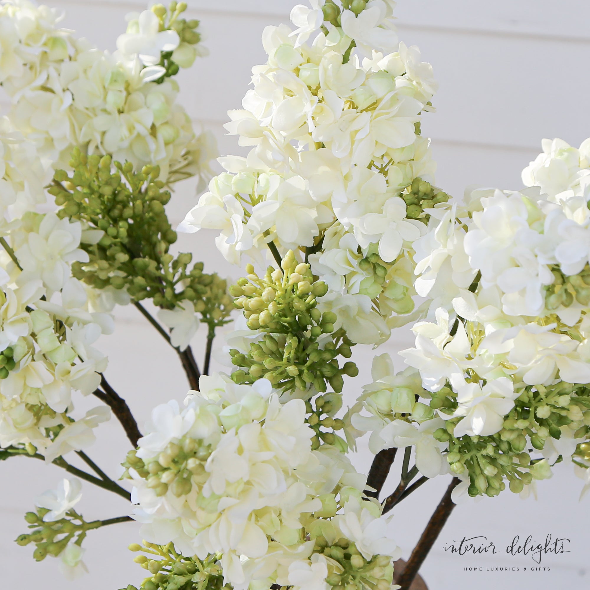 Close-up of White Lilac Spray showcasing lifelike white flowers and vibrant green buds for timeless decor.