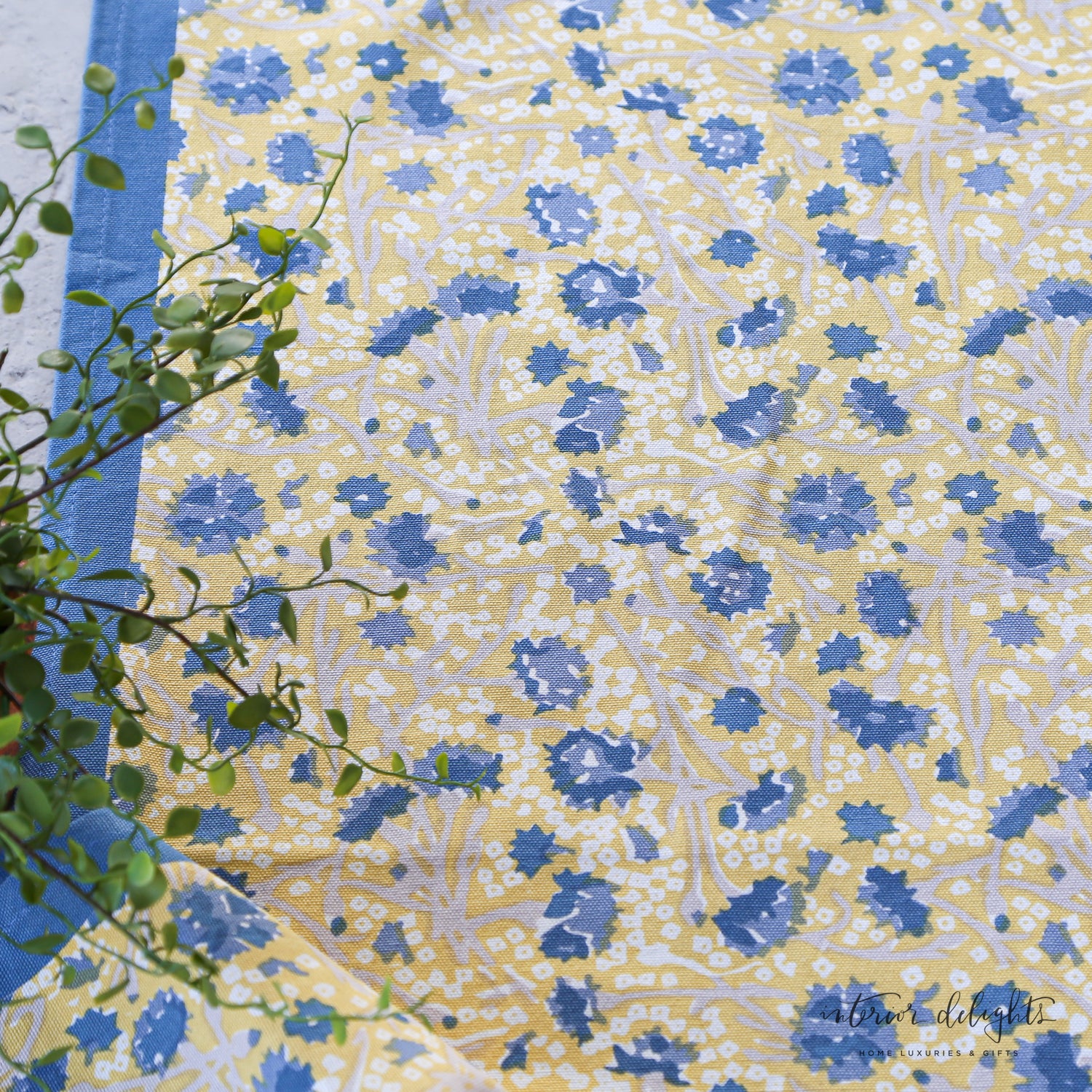 Meadows Blue and Gold Floral Table Runner in soft shades of blue, yellow, and white, showcasing its elegant floral design perfect for any seasonal table setting.