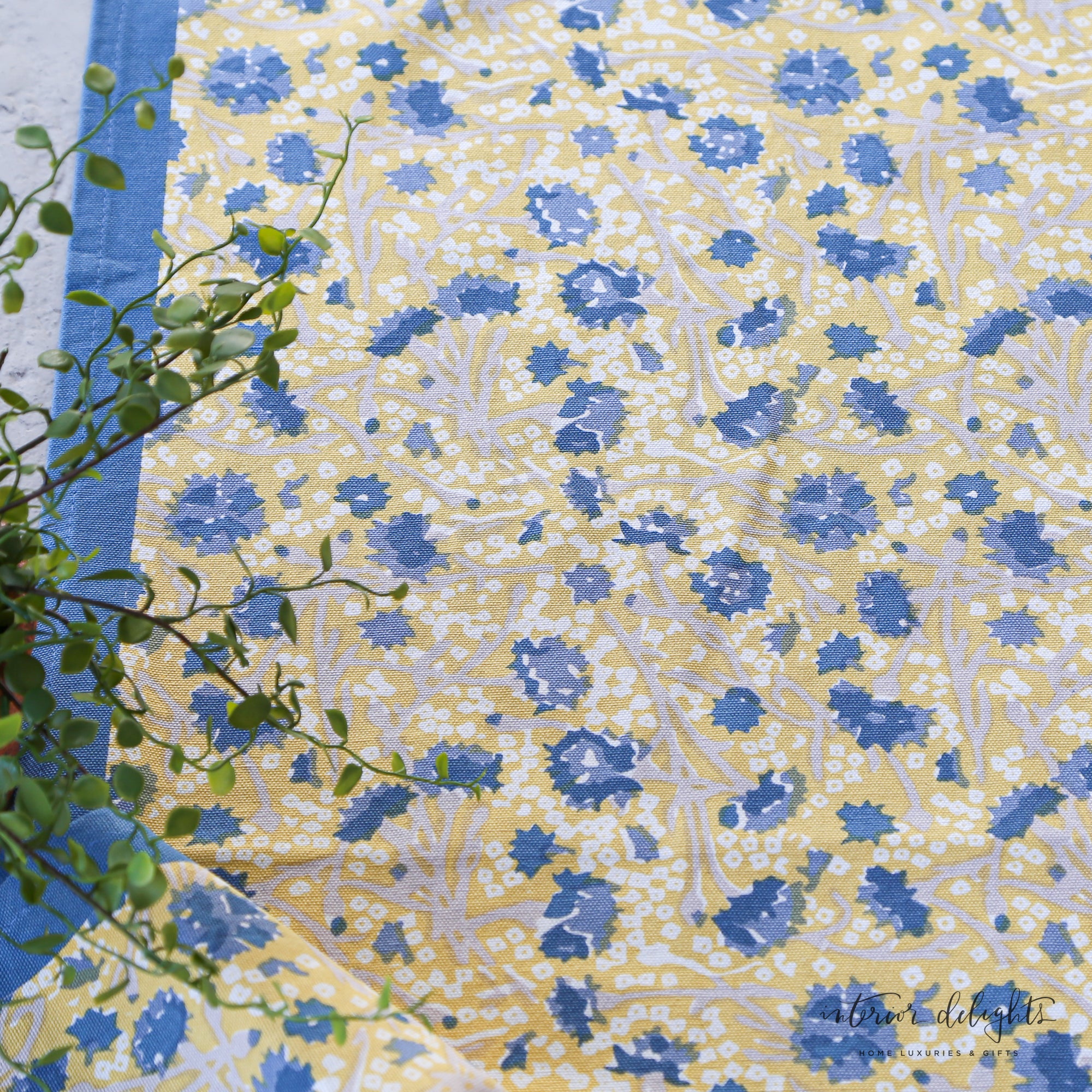 Meadows Blue and Gold Floral Table Runner in soft shades of blue, yellow, and white, showcasing its elegant floral design perfect for any seasonal table setting.