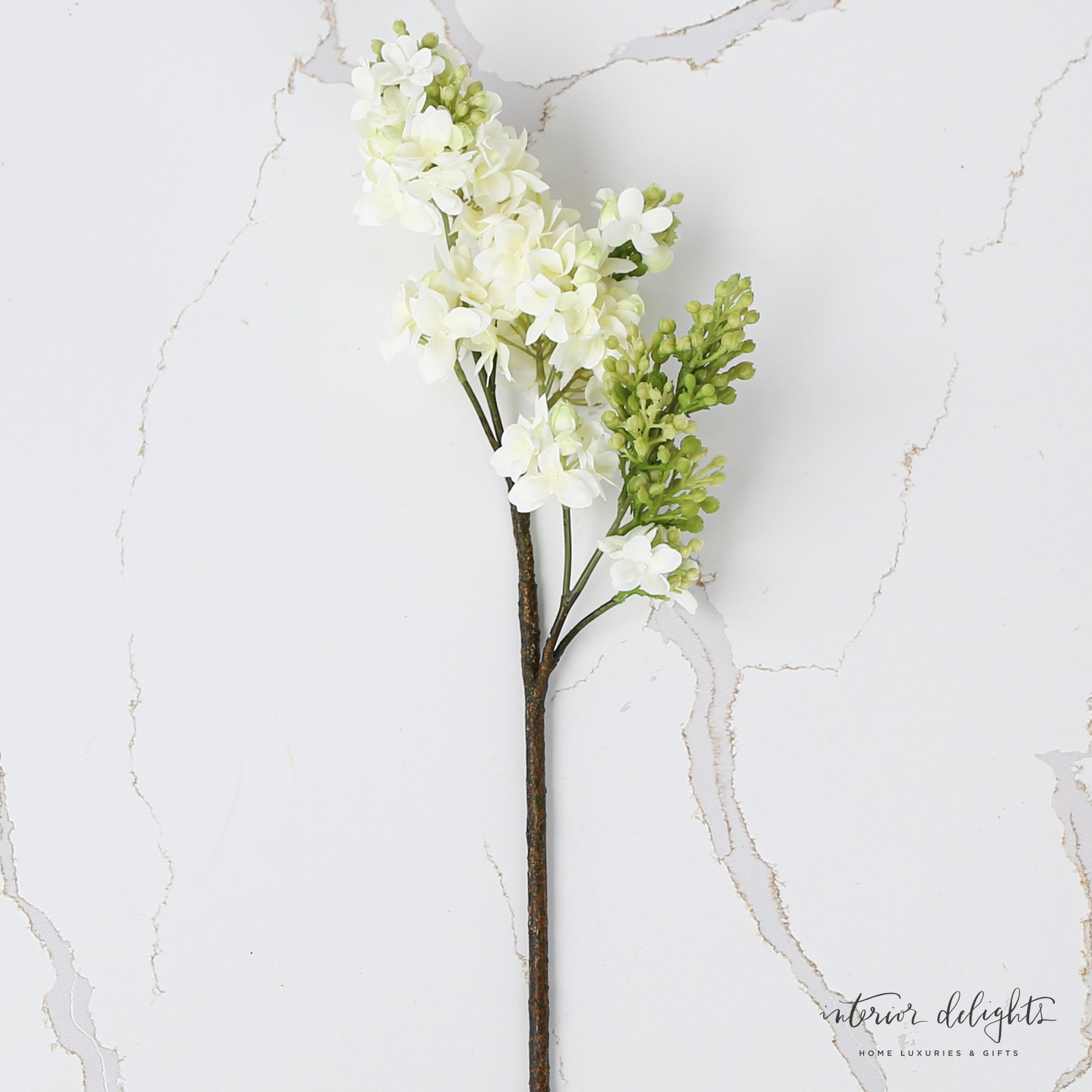 White Lilac Spray displayed in a vase, highlighting its graceful 25-inch length and beauty in home decor.