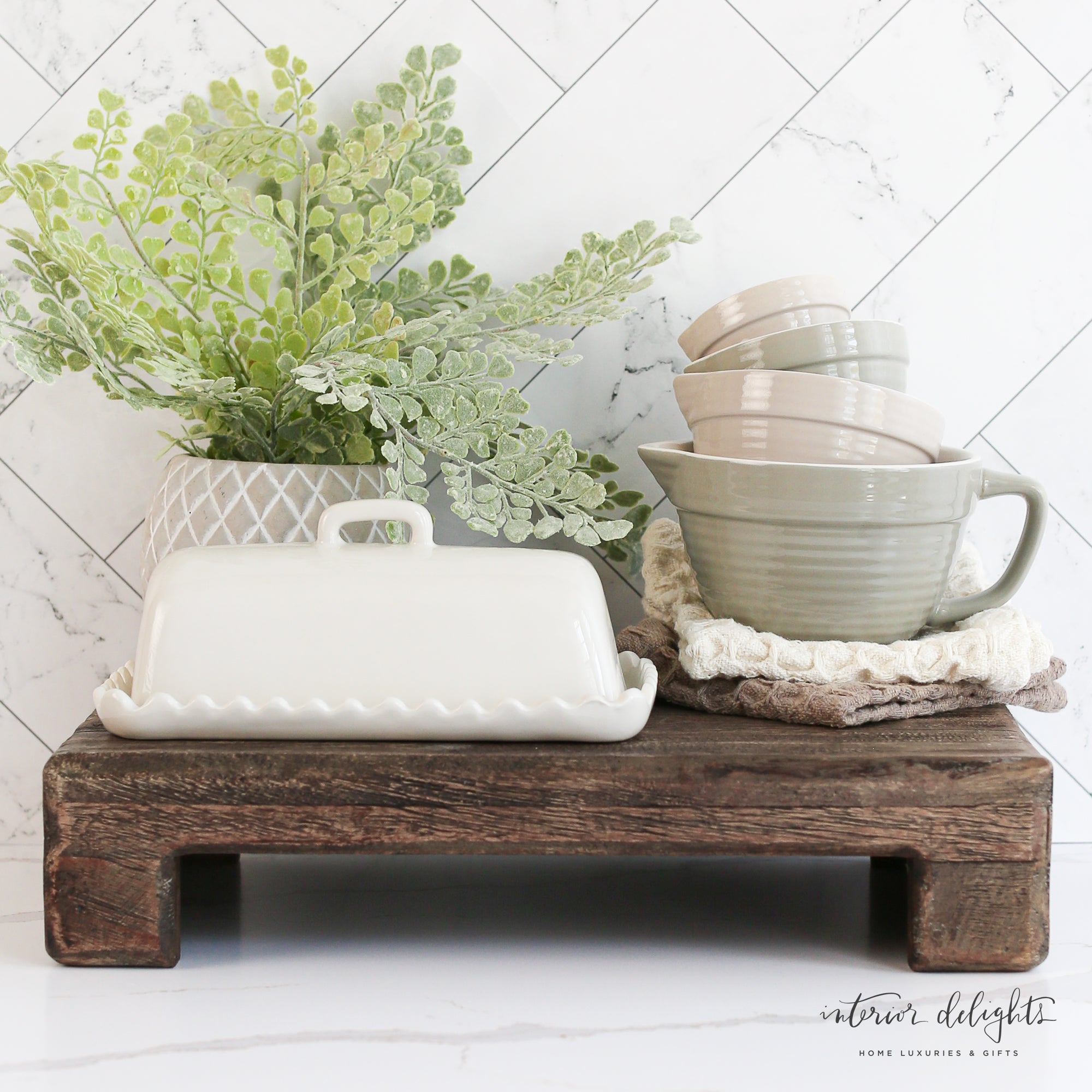 White Scalloped Butter Dish elegantly displayed holding a stick of butter, perfect for adding charm to your kitchen.
