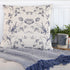 Cotton and Linen Square Pillow with blue floral print on a cozy couch.