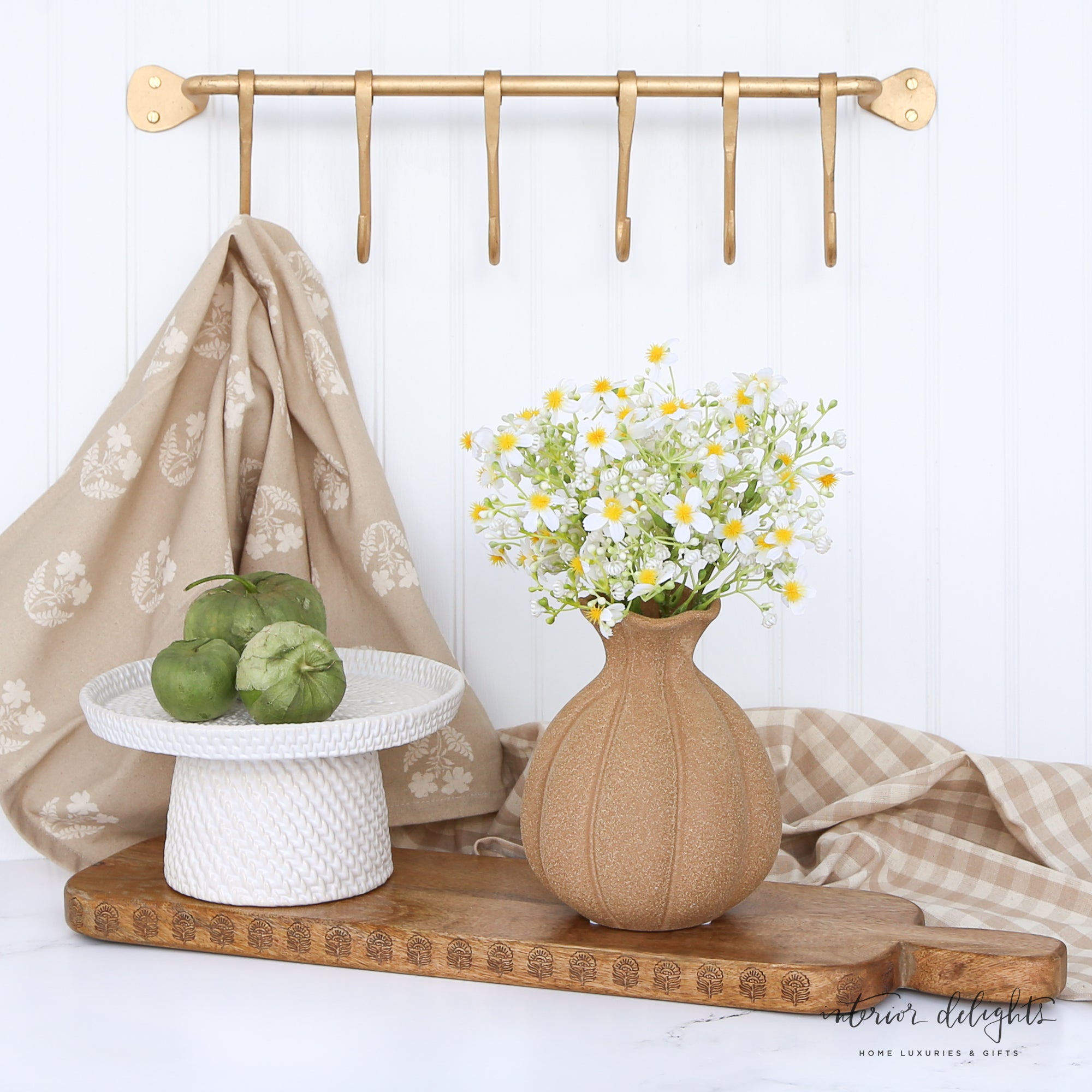7” Brown Stoneware Vase next to green foliage, illustrating its versatile decor appeal.