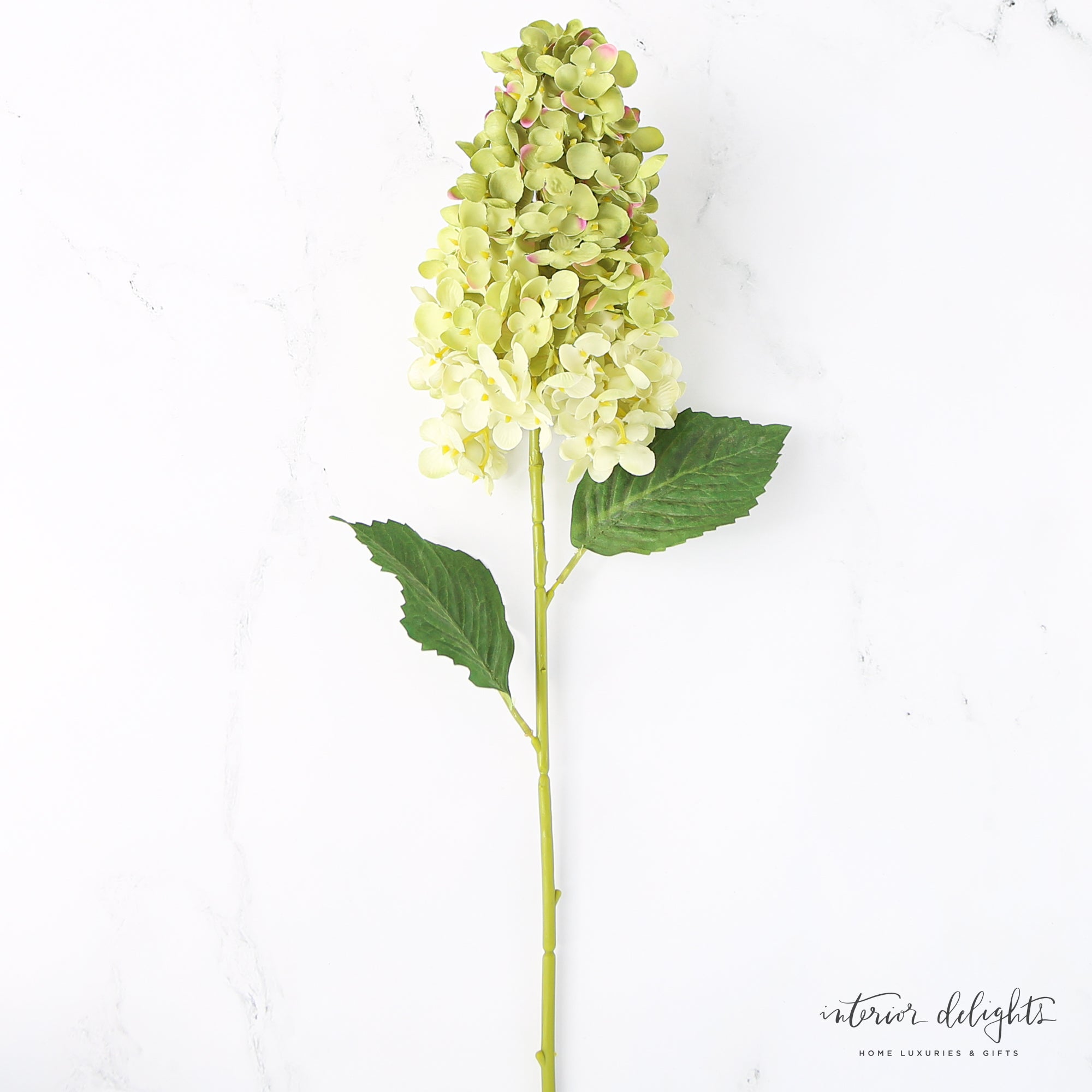 Three Summit Hydrangea Stems in cream, green, and blue arranged beautifully in a seagrass vase.