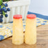 Bright yellow salt and pepper shakers with orange tops, perfect for adding a pop of color to your kitchen or dining table.