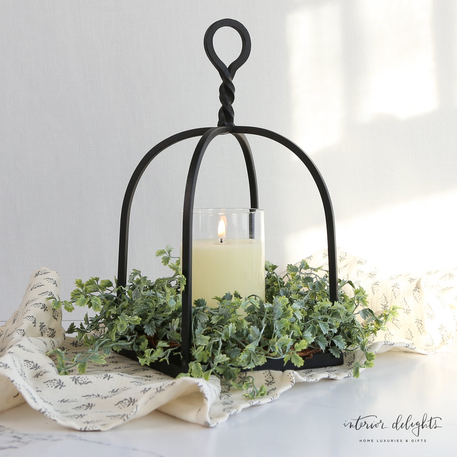Close-up view of the Shively Greens Candle Ring 12in highlighting its realistic green foliage and versatile design for various candle sizes.