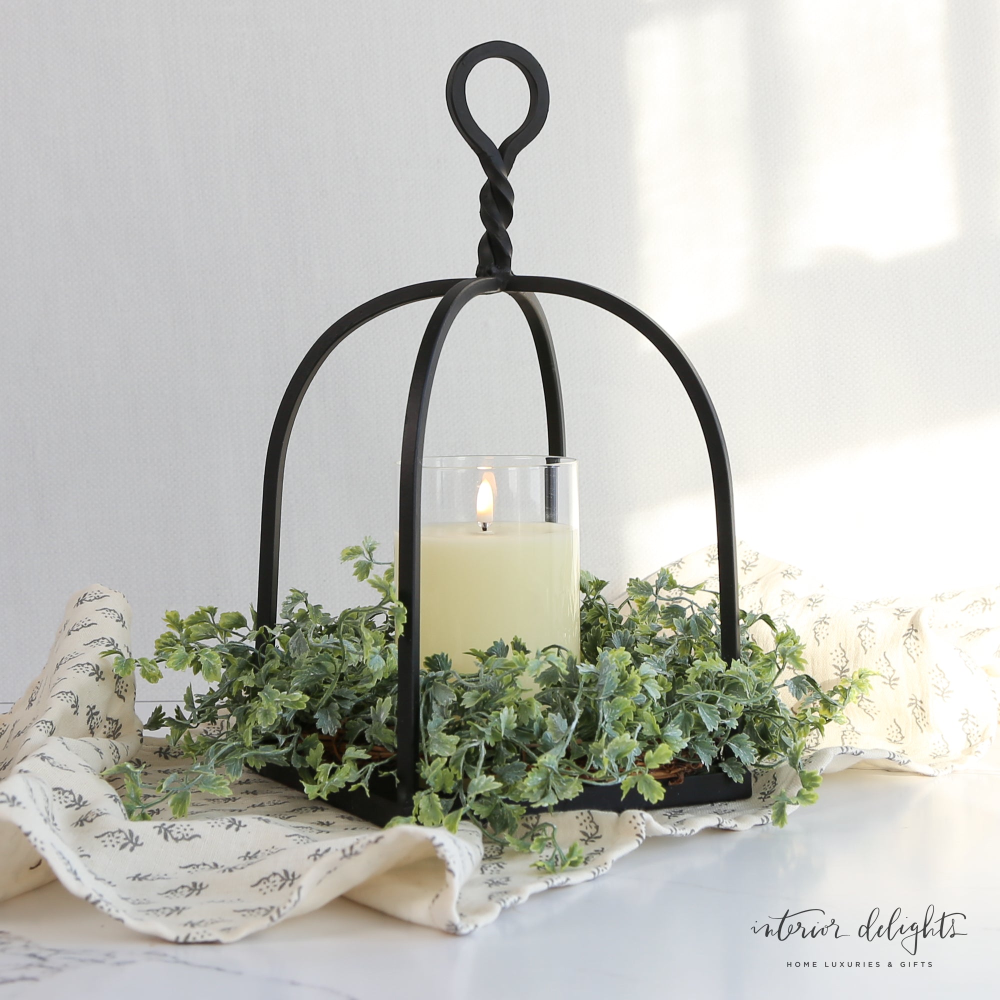 Close-up view of the Shively Greens Candle Ring 12in highlighting its realistic green foliage and versatile design for various candle sizes.