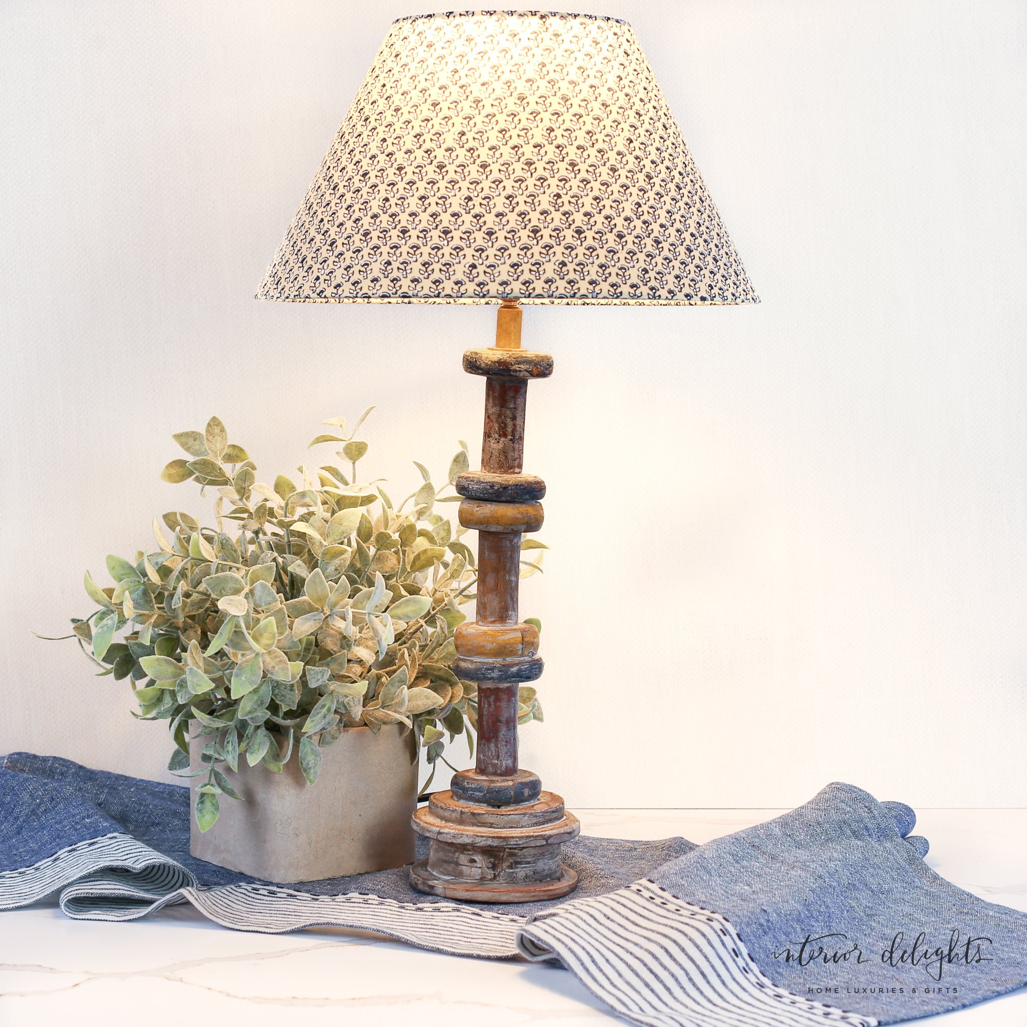 Close-up of the Wooden Spool Table Lamp displaying the rustic charm and character of the reclaimed wood.