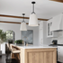 Brady Matte Black Pendant White Shade hanging in a modern living room, showcasing its stylish design and elegant fabric shade.