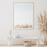 Wild Mountain Horses artwork depicting a group of horses trotting across a soft-toned landscape under a clear blue sky, beautifully framed in light wood, perfect for wall decor.