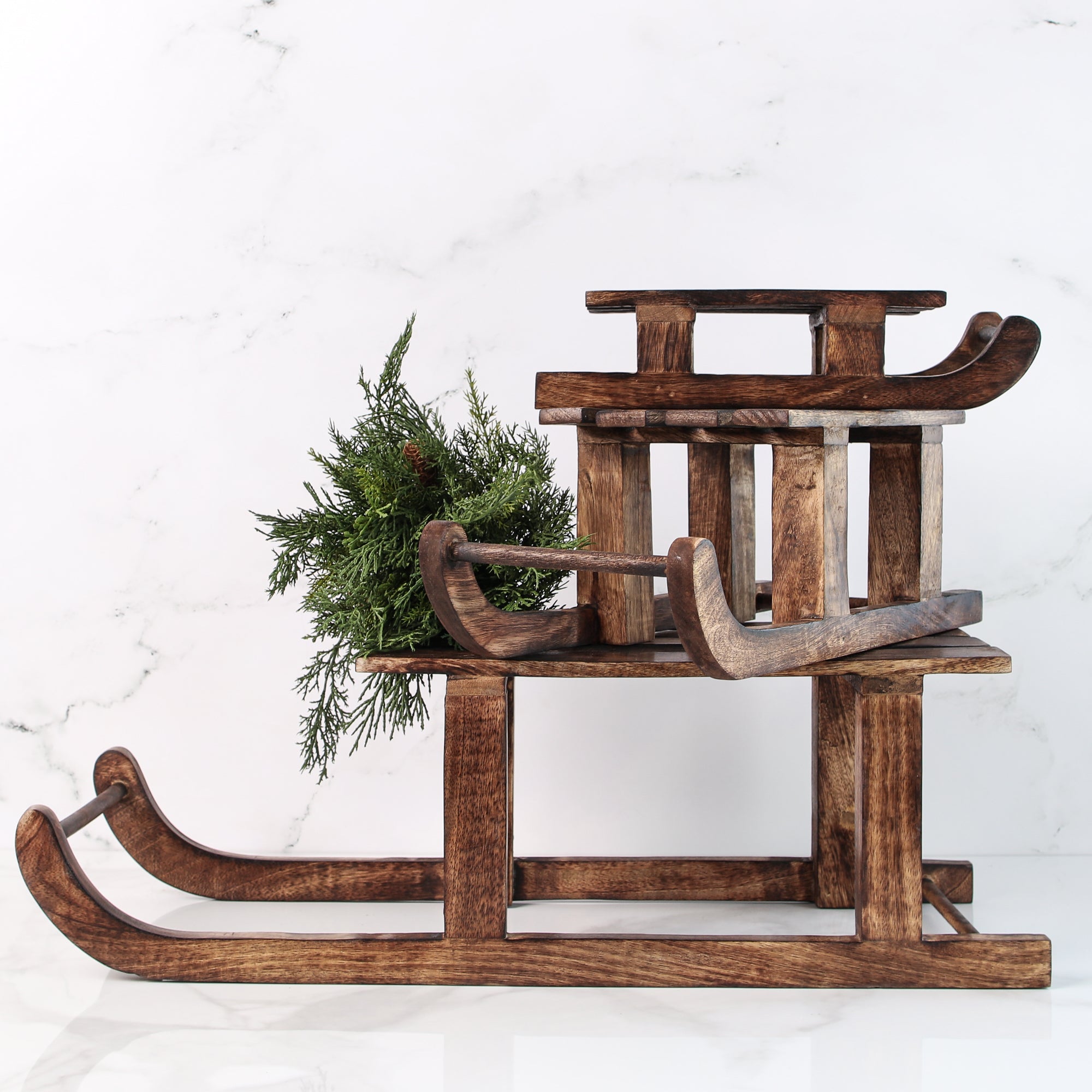 ARRANGEMENT: Sled Risers with Pinecones and Glitter Wreaths