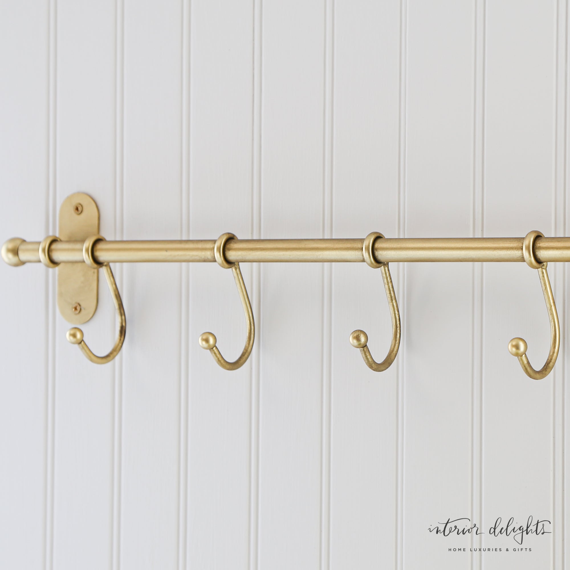 Antiqued Metal Wall Hooks, featuring five sturdy hooks for organizing coats and kitchen items, perfect for adding vintage charm to any space.